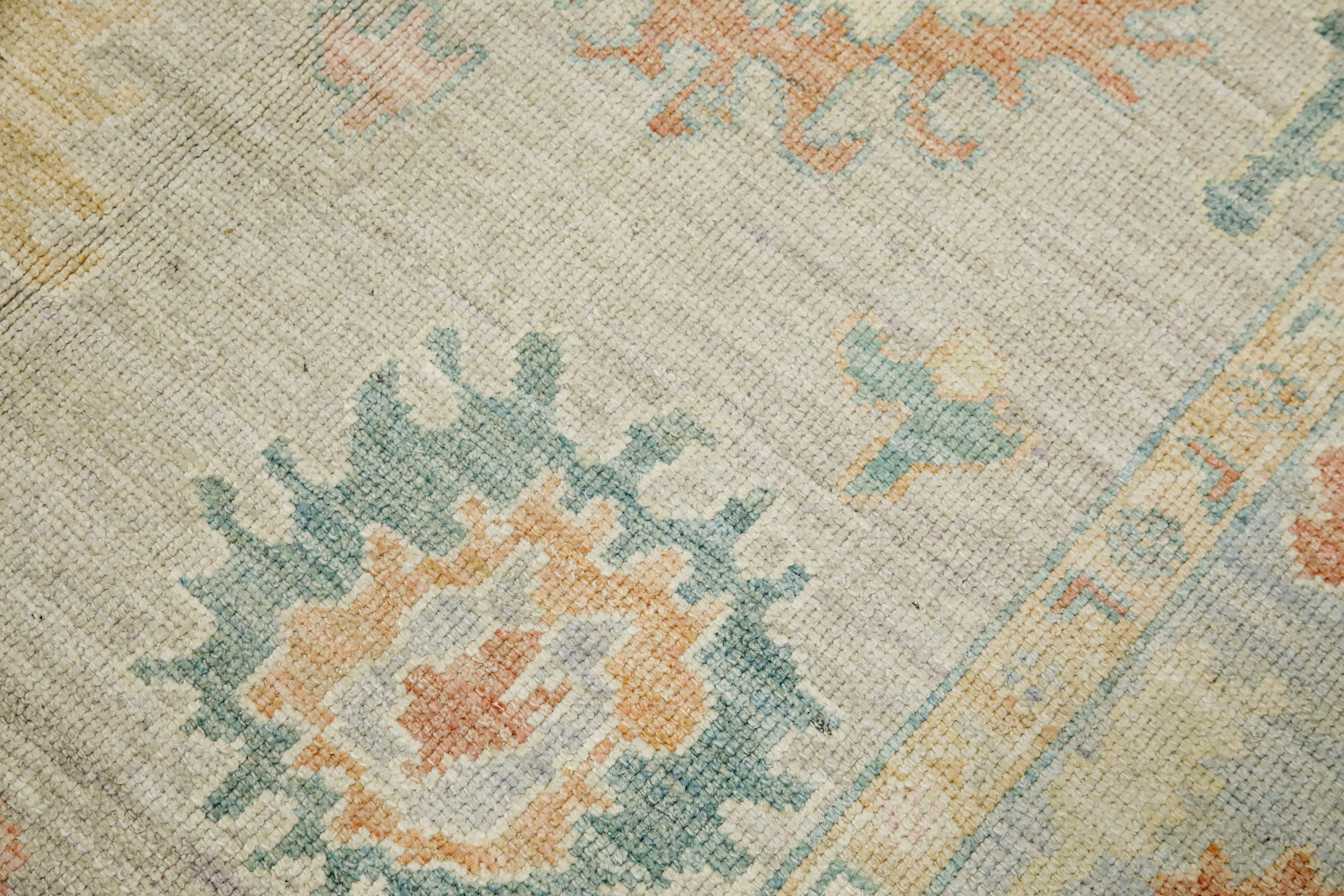 This modern Turkish Oushak rug is a stunning piece of art that has been handwoven using traditional techniques by skilled artisans. The rug features intricate patterns and a soft color palette that is achieved through the use of natural vegetable
