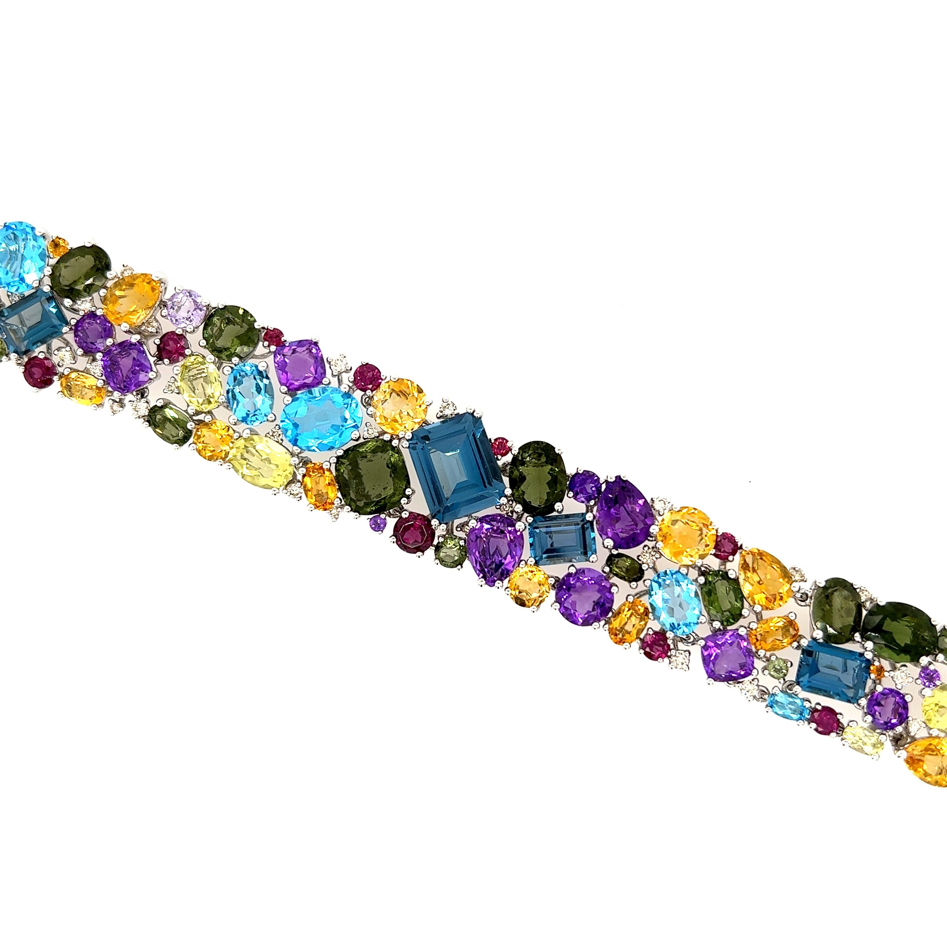 This colorful bracelet is comprised of 66 semi-precious gems, equalling 60.05 Cts. Also there are .71 Cts of diamonds included in this magnificent bracelet. The semi-precious gems are held together by a 14Kt white gold lacing. 


