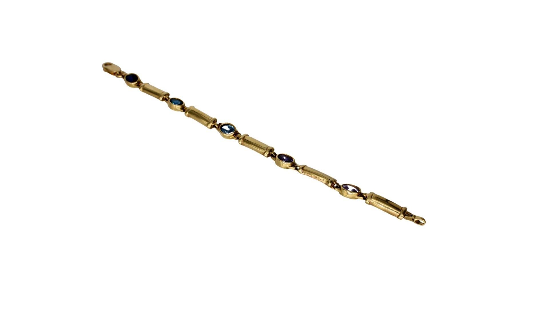 Bold and elegant, this multi-color bracelet over 14 carats features various shapes of blue gemstones, pink gemstones,   purple spinel gemstones. These vibrant gemstones are framed with a sparkling halo of diamonds set in 14k yellow gold.

*gold