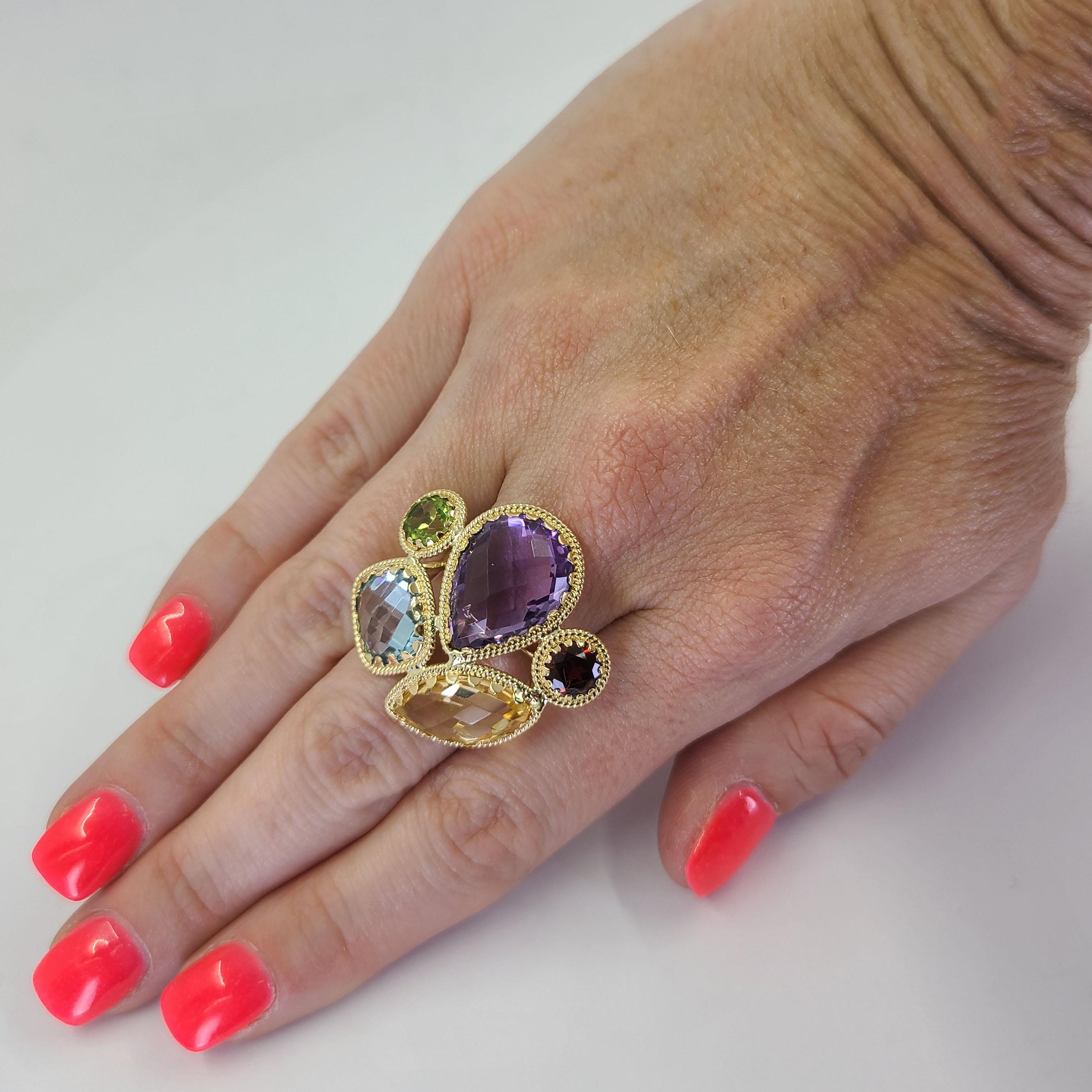 18 Karat Yellow Gold Multicolor Cocktail Ring Featuring A Pear Cut Amethyst, Marquise Cut Citrine, Cushion Cut Blue Topaz, Round Cut Garnet, and Round Cut Peridot. Finger Size 6.5; Purchase Includes One Sizing Service Prior to Shipment. Finished