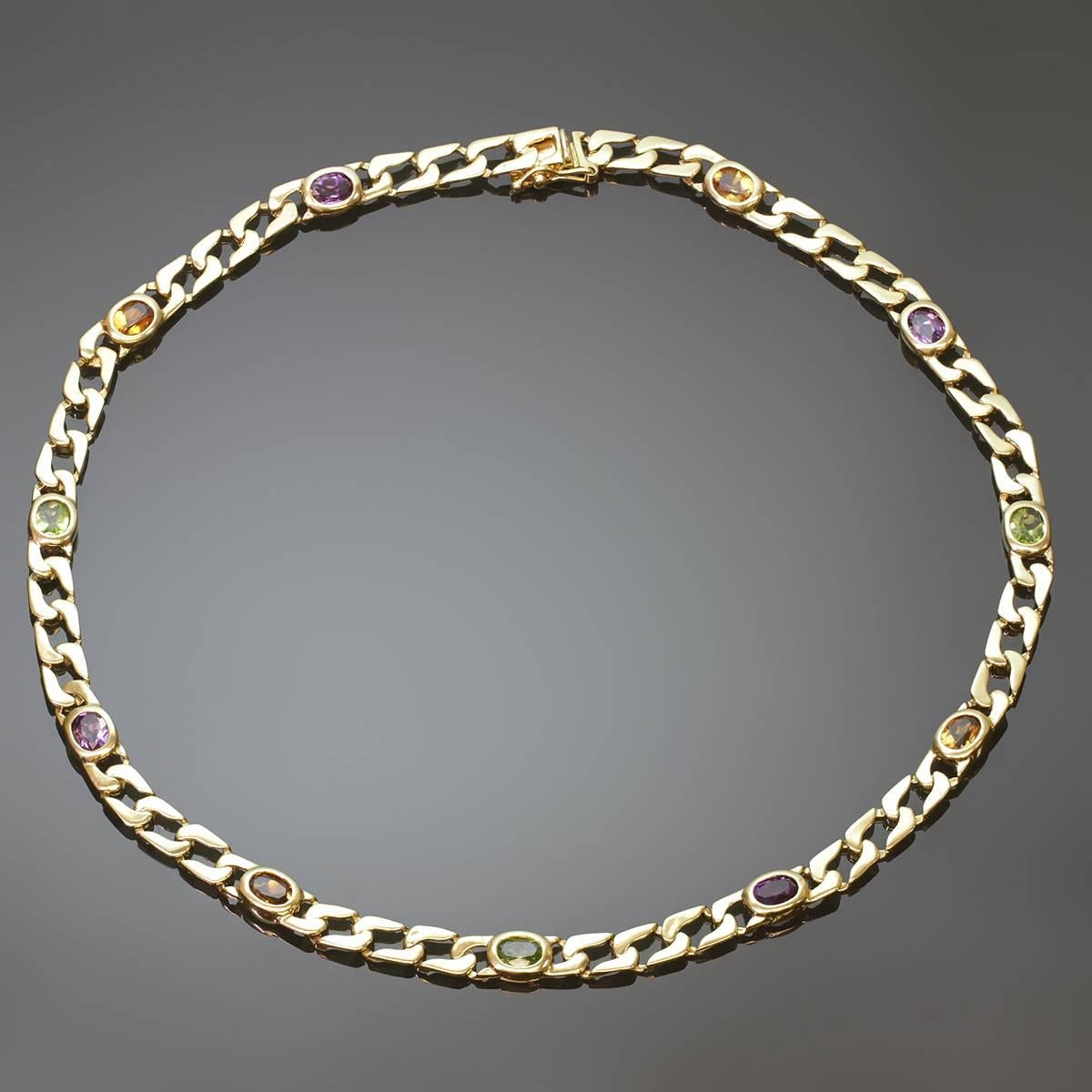 This classic vintage necklace features oval links bezel-set with faceted precious stones - green peridot, orange citrines, and purple amethyst - on a curb chain made of textured 14k yellow gold. A romantic and elegant design. Circa 1980s.