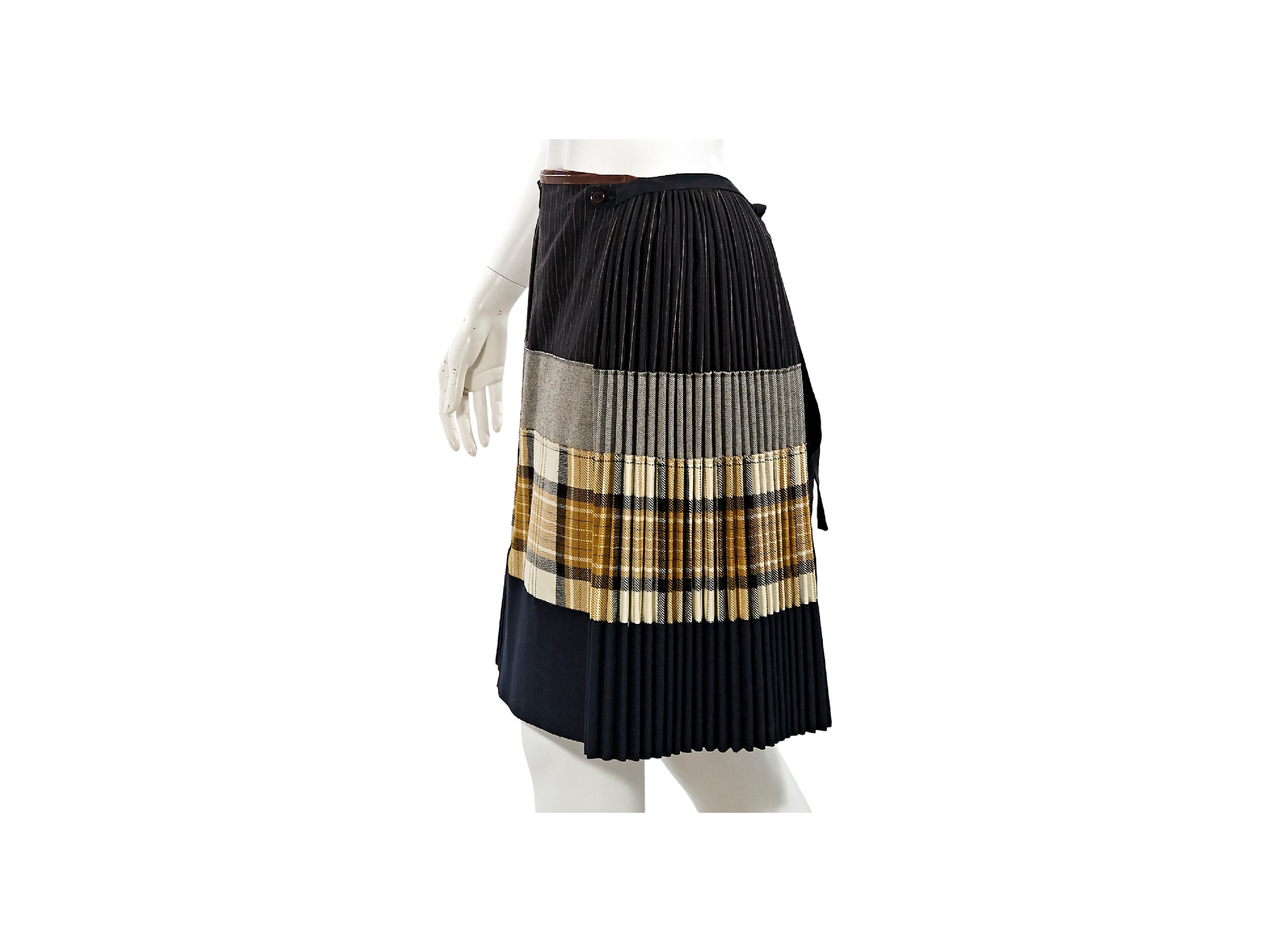Product details:  Multicolor patchwork-style pleated wool skirt by Jean Paul Gaultier.  Button front with tie-back closure.  26