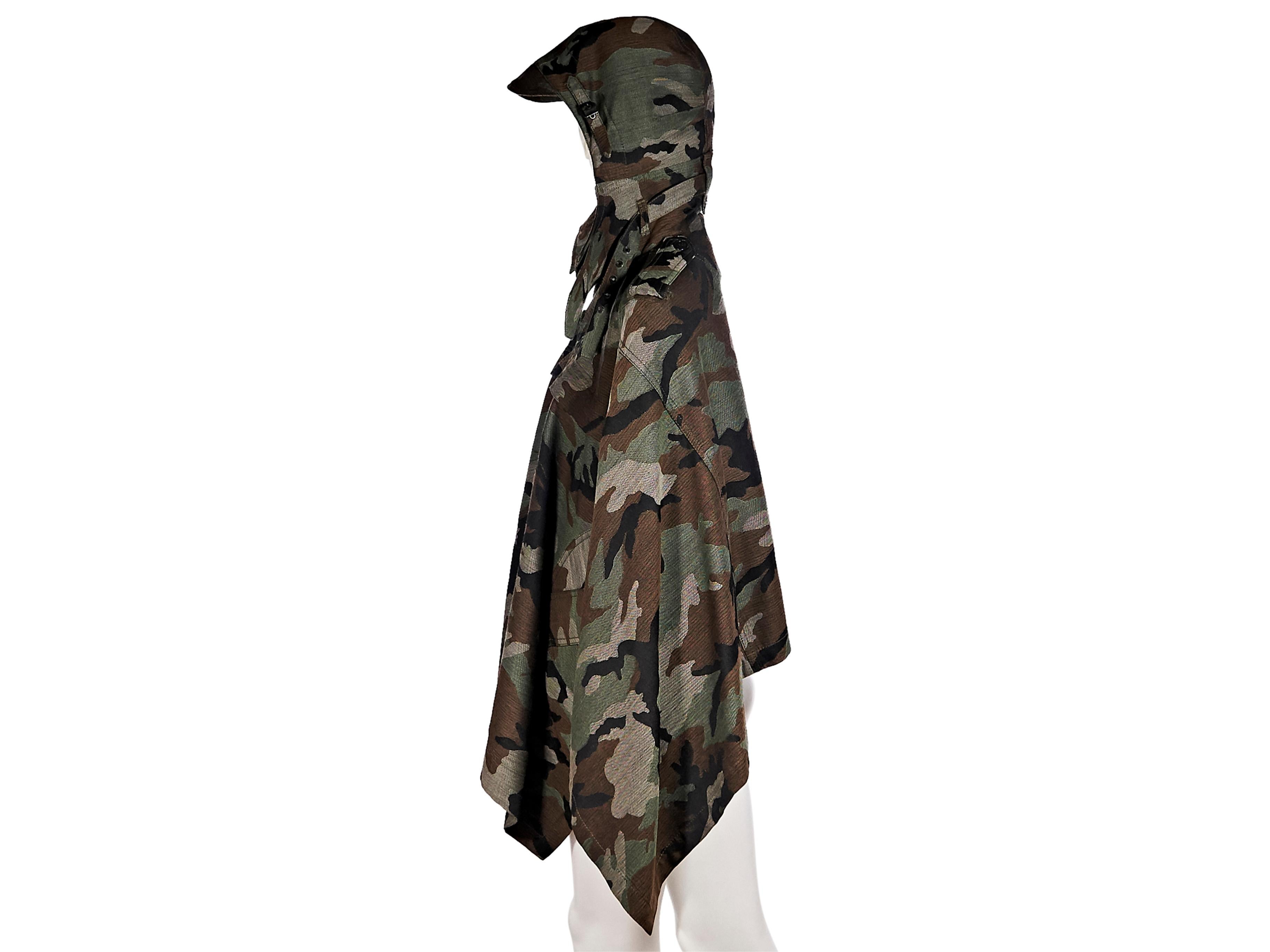 Product details:  Multicolor camo wool poncho by Junya Watanabe Comme des Garcon.  From the FW 2010 collection.  Hood with adjustable buckle closure.  Spread collar.  Shoulder epaulettes.  Long sleeves.  Waist button flap pockets.  34