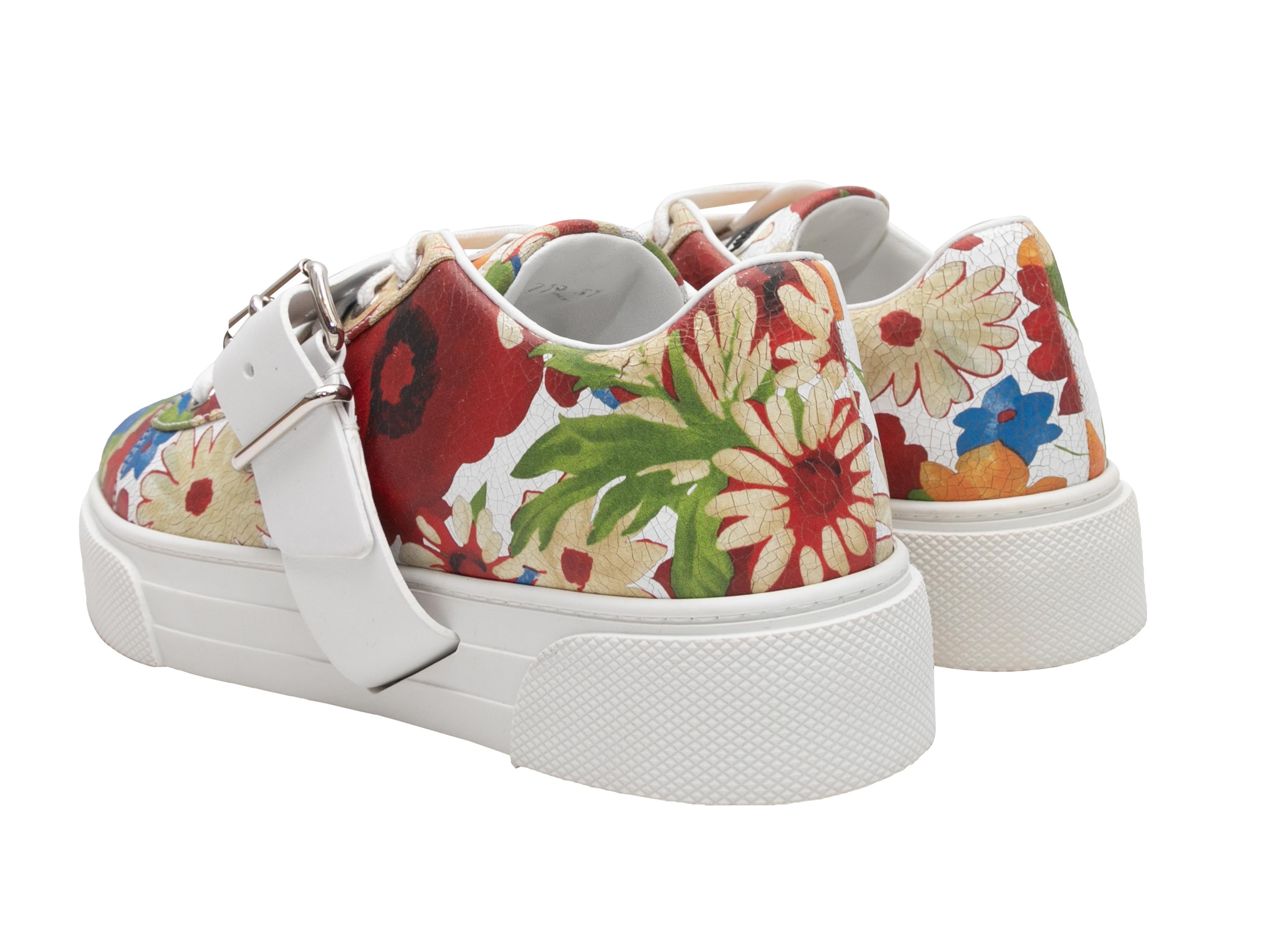 Multicolor floral print leather low-tope buckle strap sneakers by Miu Miu. Rubber soles. Lace-up tie closures at tops. 1.5