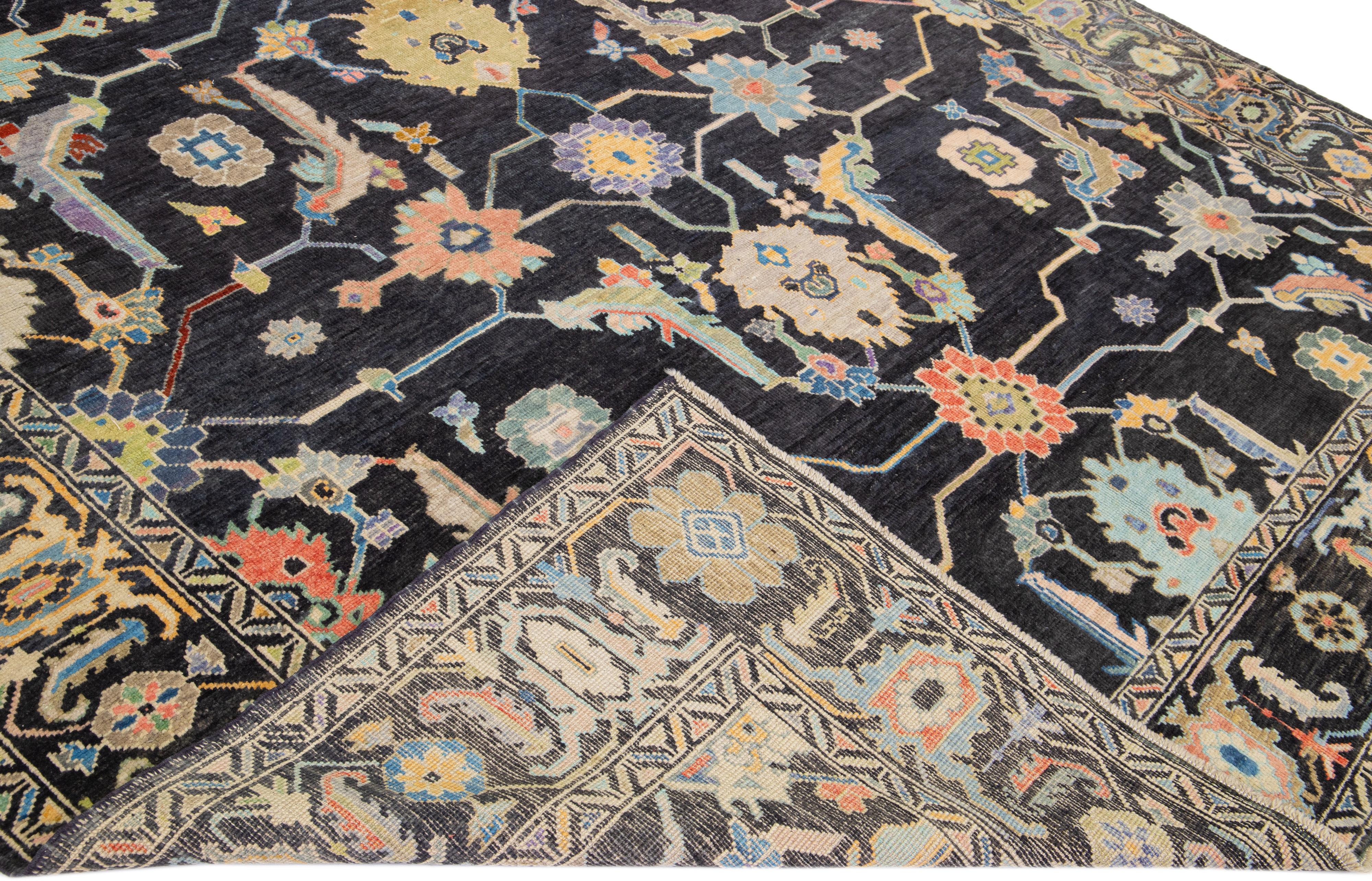 Beautiful modern Oushak hand-knotted wool rug with a charcoal field. This Turkish rug has a designed frame with multicolor accents in a gorgeous all-over floral design.

This rug measures: 9'11