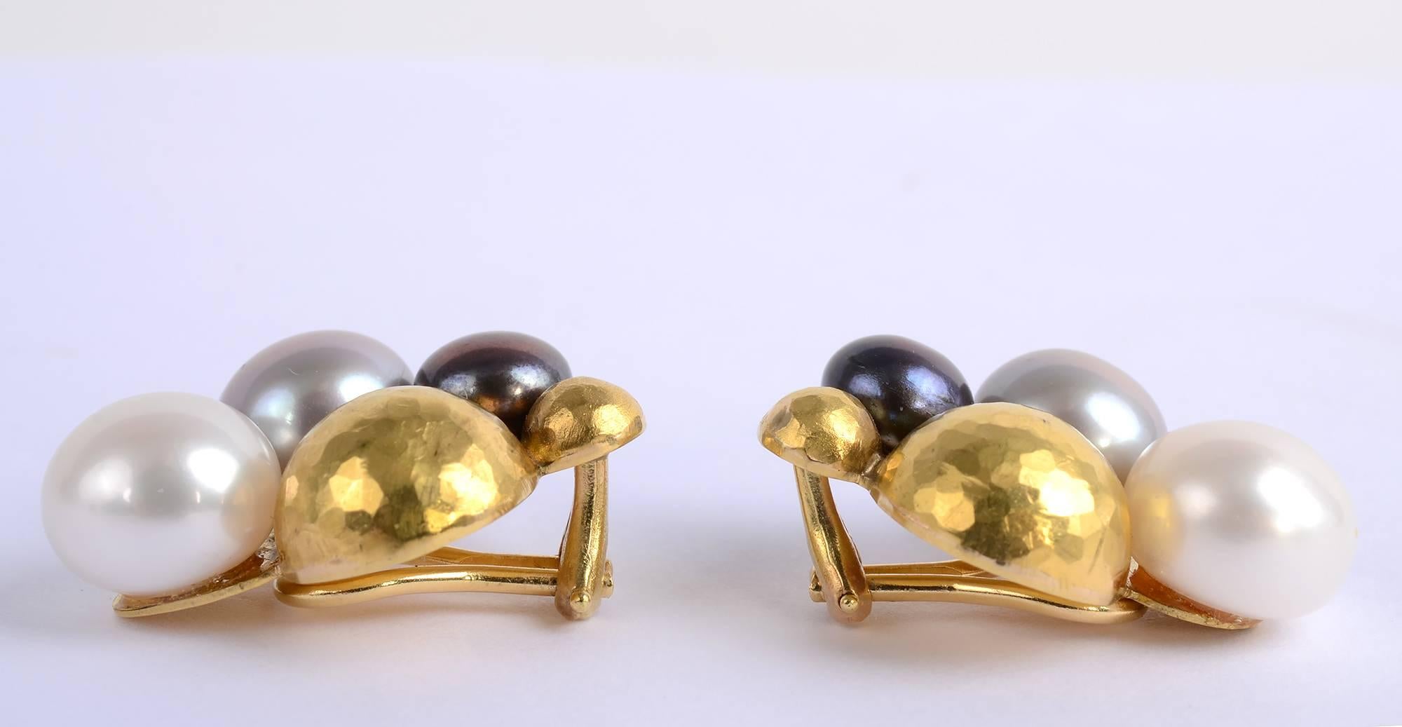 Handmade earrings with black, white and gray pearls and hammered gold balls. The white pearl, which is the largest, is approximately 11 mm.  The dyed black pearl is the smallest, measuring 7.6 mm.
Made of 18 karat gold. Clip backs can be converted