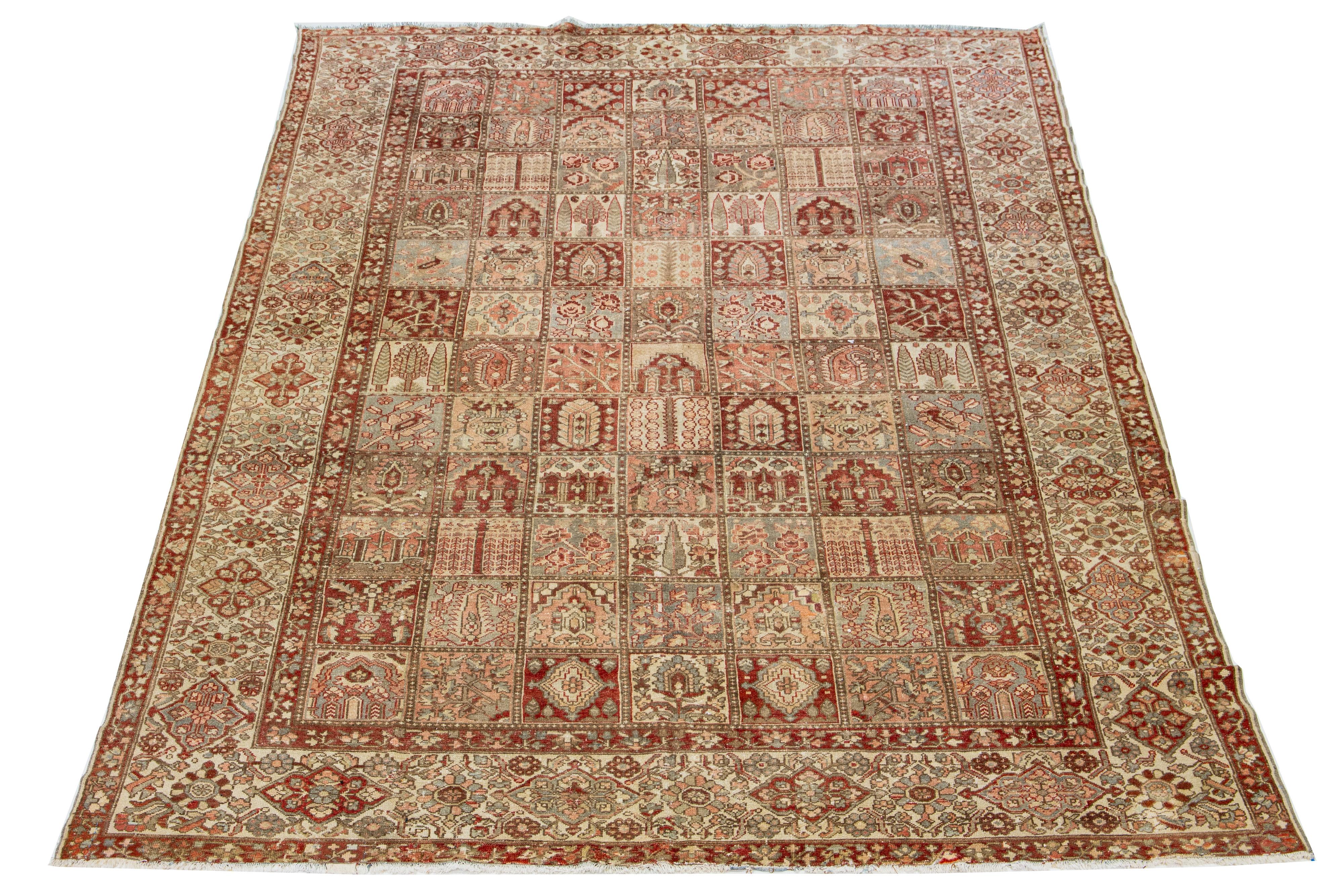 Beautiful Antique Bakhtiari hand-knotted wool rug with a red-rust, blue, beige, and peach color field. This Persian piece has a classic floral pattern.

This rug measures 10'9