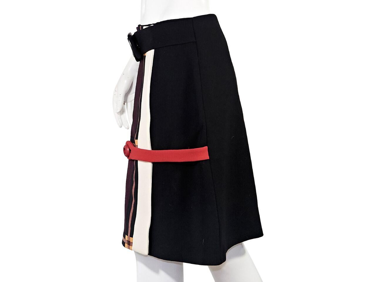 Product details:  Multicolor virgin wool A-line skirt by Prada.  Belted-front waist.  Red button strap detail.  29
