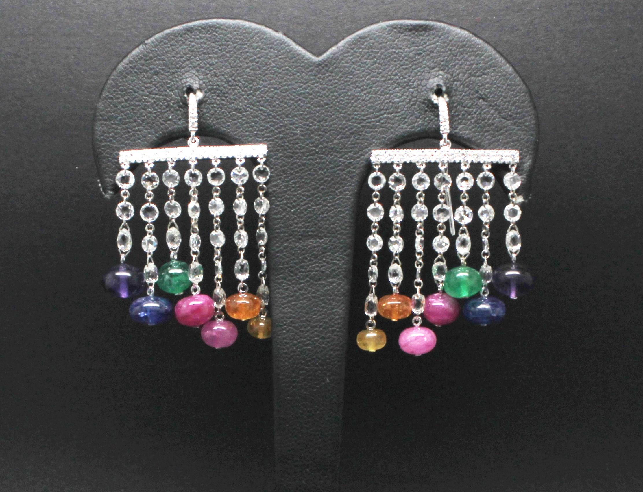 Easy-wear Dangle Earrings, with Multi-Strand Diamond-Chains ended by Colour gemstones.
In these Dandle Earrings are:
emerlad 2.80Kt 
ruby 4.20Kt
blu/pink/yellow sappirhe 9.84Kt
amethyst 3.70Kt
spessorite 2.87Kt
diamonds 3.94Kt

This jewel is