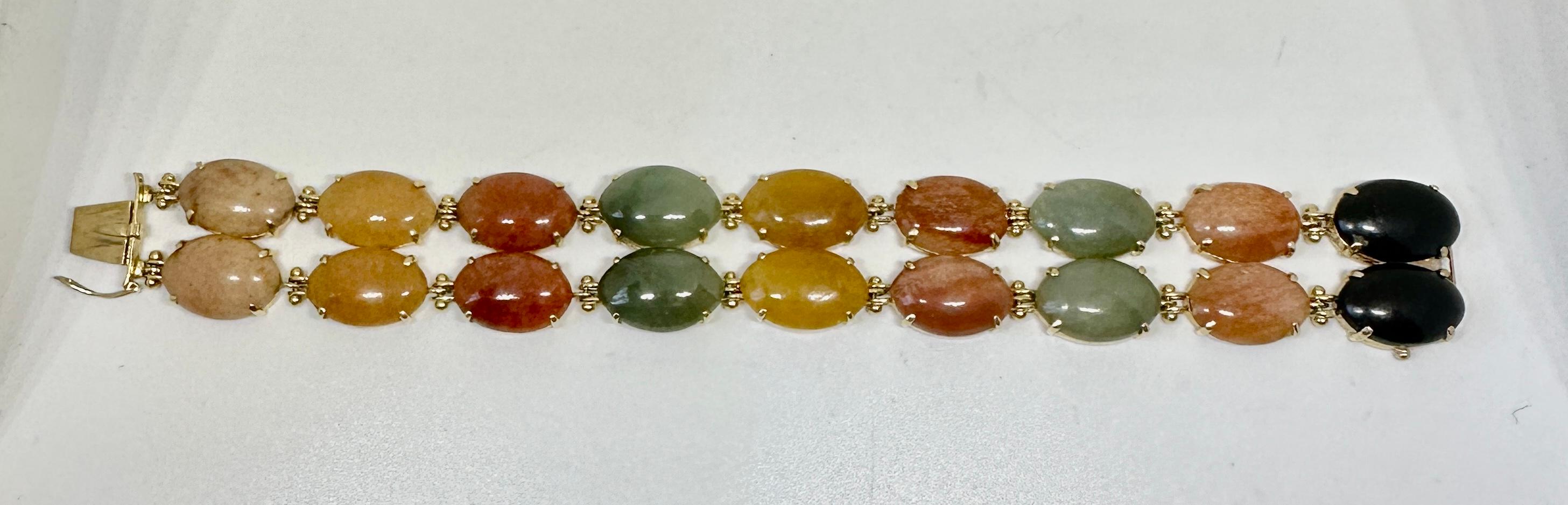 Indulge in a gorgeous vintage retro multi-color rainbow jade bracelet in a double cabochon design in 14 Karat Yellow Gold.  The exquisite jade bracelet has 18 of the most fabulous multi color jade cabochons including yellow jade, red jade, green