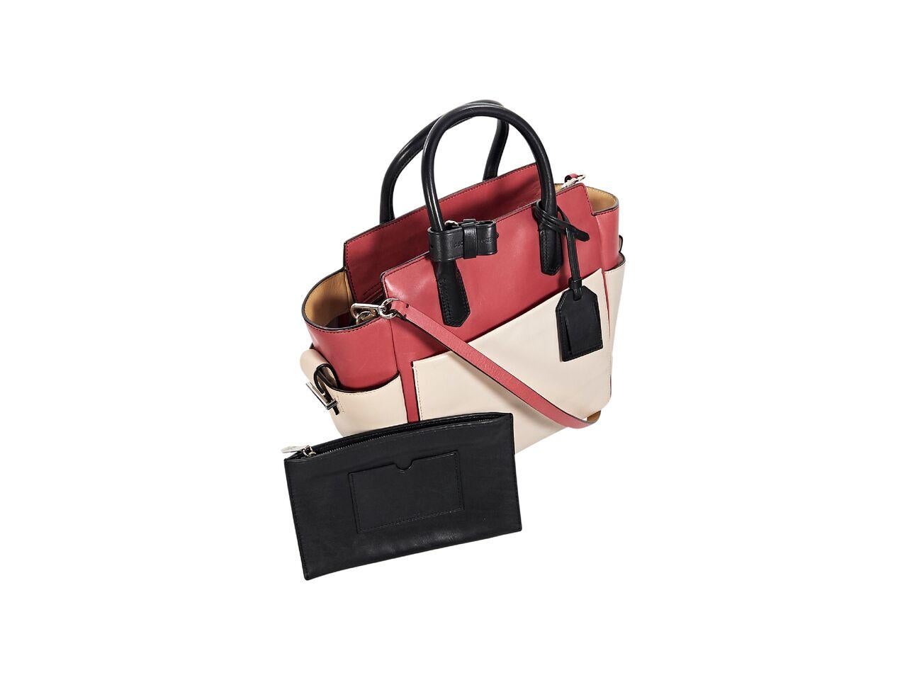 Product details:  Pink, beige and black leather satchel by Reed Krakoff.  Dual carry handles.  Detachable, adjustable crossbody strap.  Top zip closure.  Lined interior with inner zip and slide pockets plus removable zip pouch.  Exterior slide