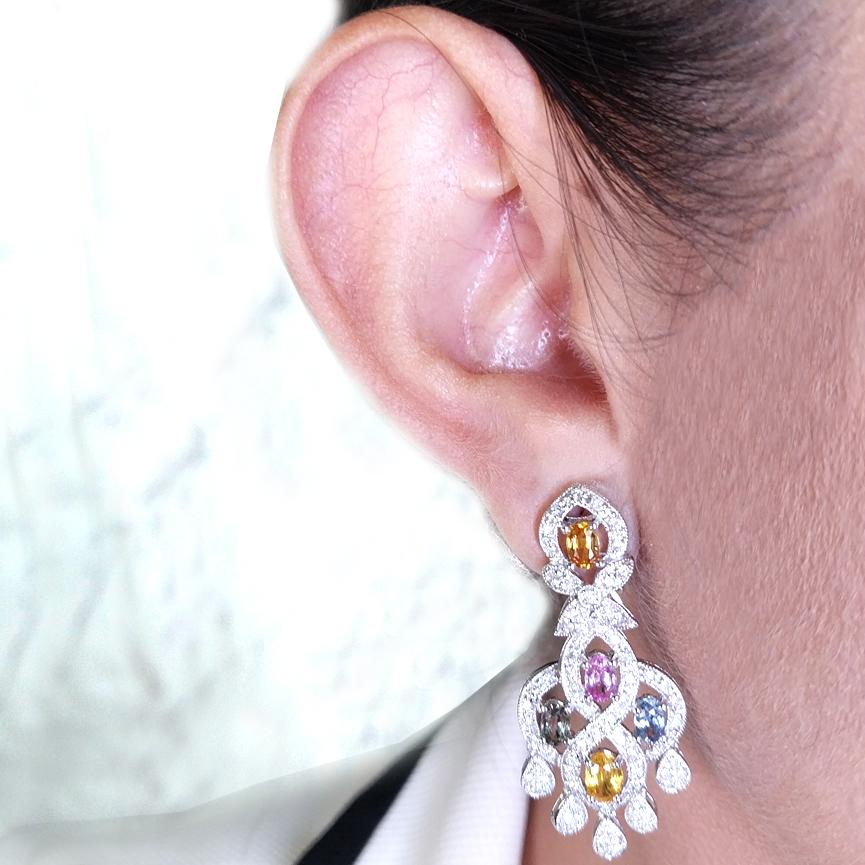14 Karat White Gold Chandelier Earrings Featuring 10 Oval Blue, Green, Yellow, Pink, and Orange Sapphires Totaling Approximately 3.50 Carats Accented by 150 Round Diamonds of SI Clarity and H Color Totaling An Additional 0.75 Carats. 1.75 Inches