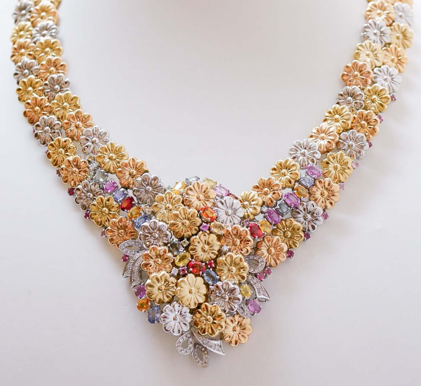 Amazing necklace in 18 kt yellow gold, rose gold and white gold structure composed by  flowers of three golden colors and, in the lower part, between of them, diamonds, and multicolor sapphires.
This necklace was totally handmade by Italian master