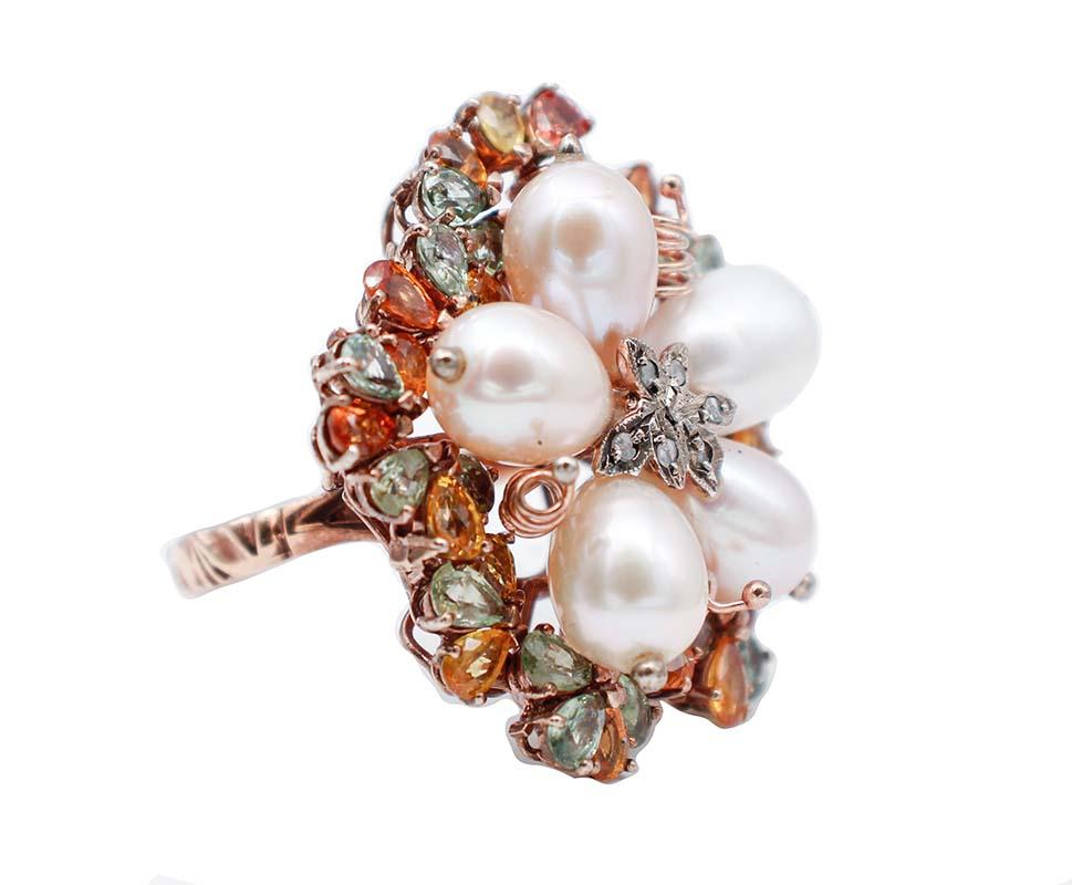 Beautiful retrò ring in 9 karat rose gold and silver structure mounted with five pink pearl and,in the center, a leave studded with diamonds. All around, multicolor sapphires.
This ring was totally handmade by Italian master goldsmiths and it is in