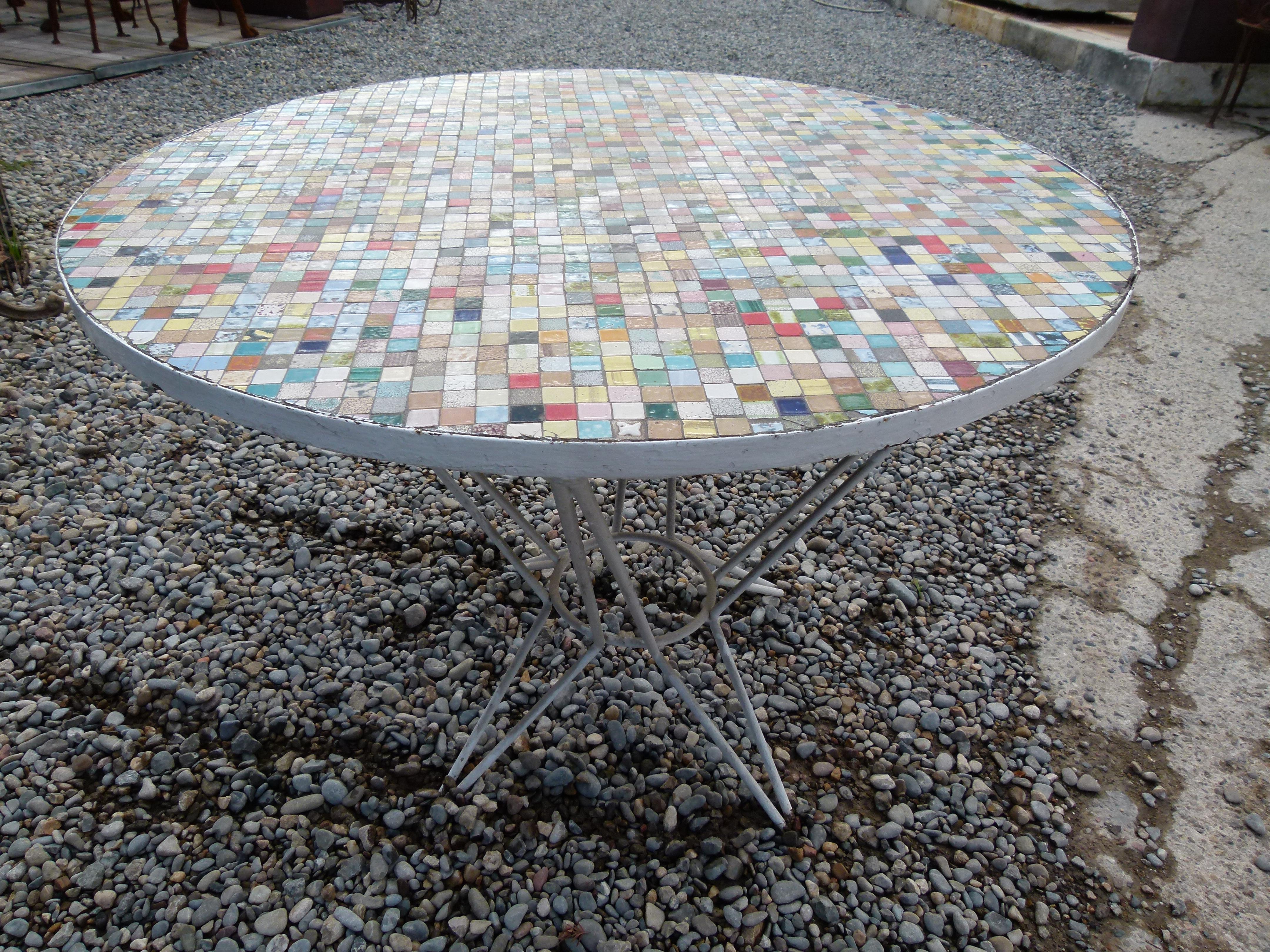 This table is made with small ceramic tiles in a various colors.The Iron base is painted in white.
Ideal as garden or terrace table. A mediterranean style garden furniture.
 