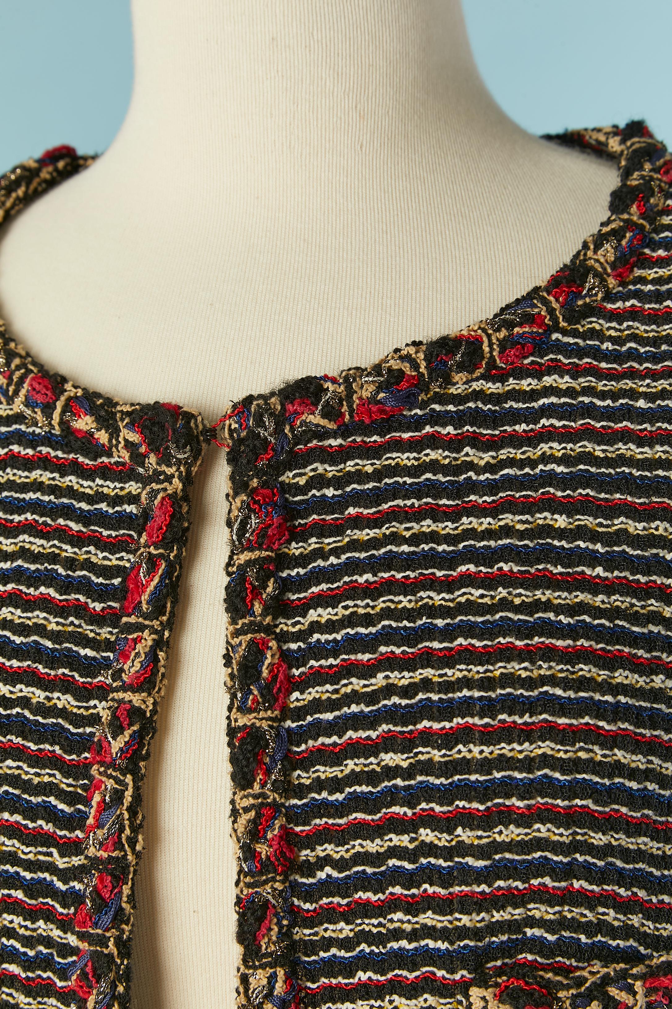 Multicolor tweed boléro jacket. Main fabric composition: 56% polyamide, 39% cotton, 5% wool. 
No lining. Edge to edge closure + one hook&eye closure  on the top middle front. Pockets with button on both side.Lurex threads on the edge. Shoulder