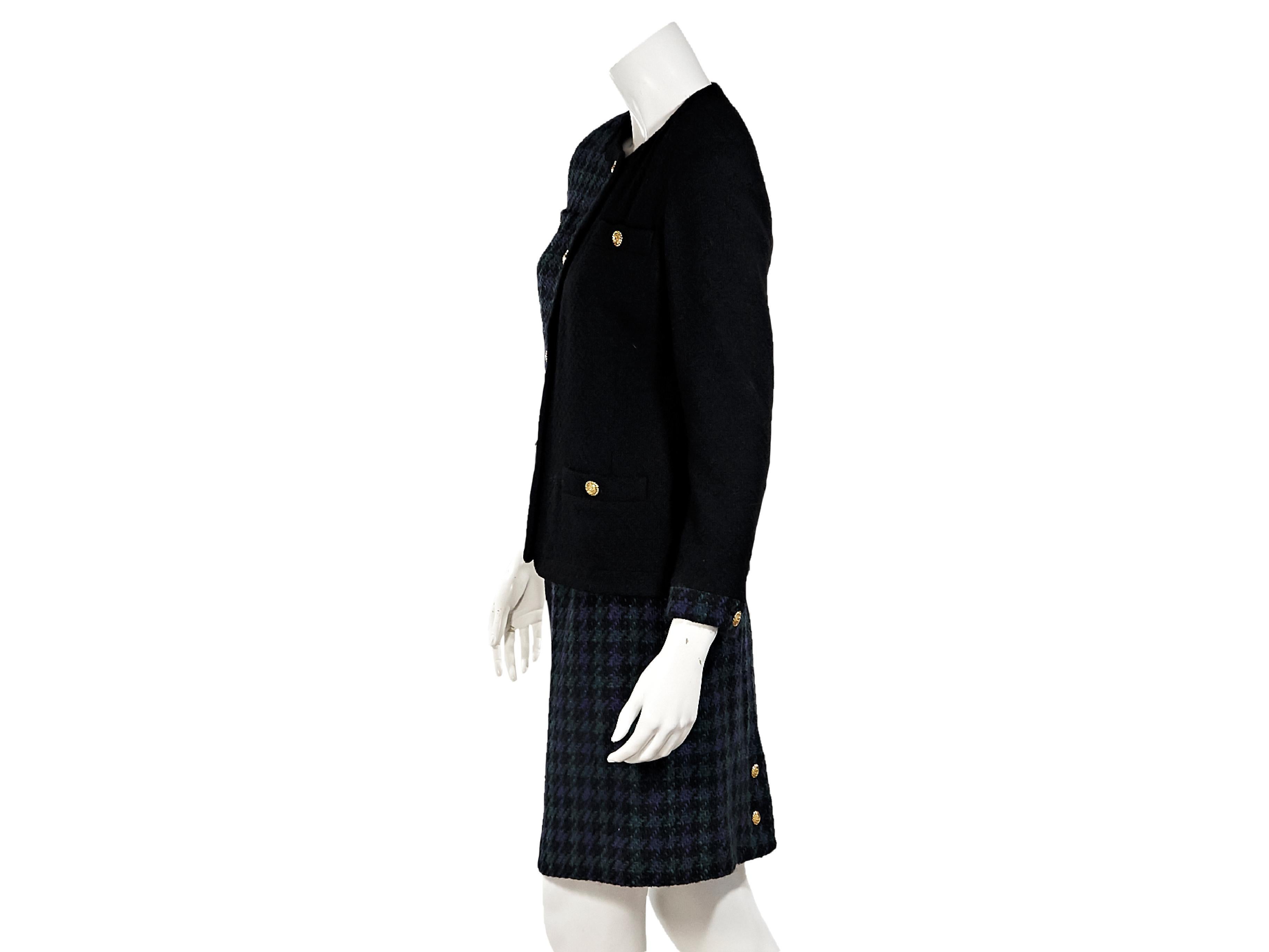 Product details:  Vintage black and green and blue tweed wool skirt suit set by Chanel.  Crewneck.  Long sleeves.  Single button cuffs.  Button-front closure.  Four front button patch pockets.  Matching pencil skirt.  Banded waist.  Concealed hook