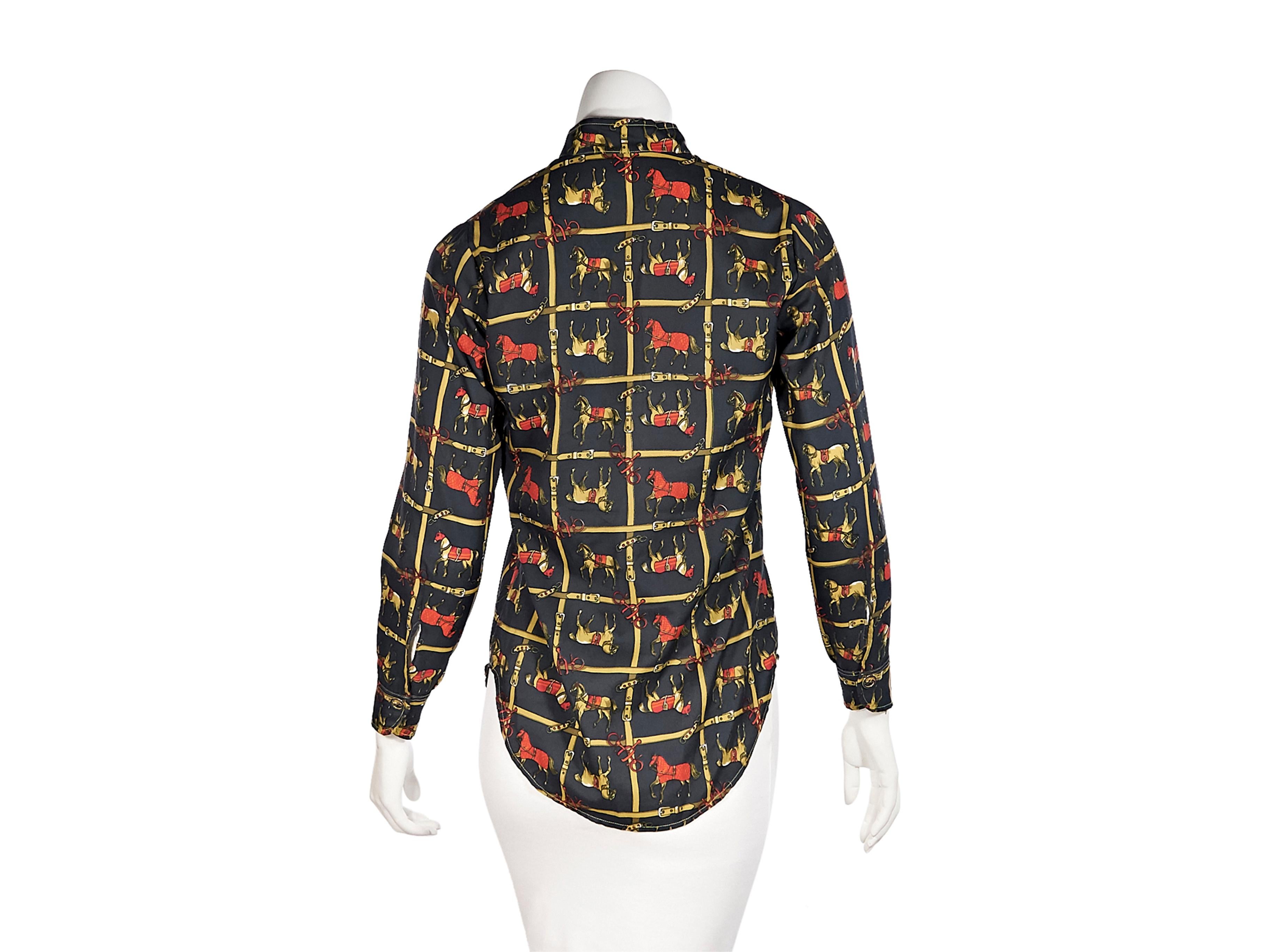 Product details:  Vintage multicolor equestrian-printed blouse by Gucci.  Stand collar.  Long sleeves.  Half button-front placket.  Single button cuff.  Shirttail hem.  Pullover style.  36