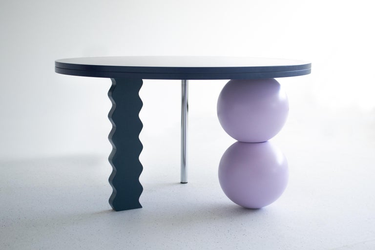 A multicolored wooden side table with solid wood spheres hand carved on a manual wood lathe, a stainless steel leg and a wavy support, without any visible screws and connections.

The bold design of this side table makes it a stand-out piece in the
