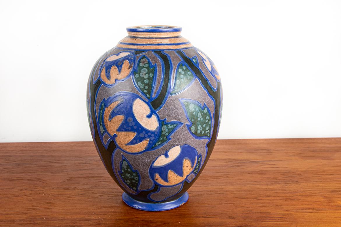 Magnifico vaso Art Nouveau con motivi floreali in blu, rosa, nero e verde, altamente decorativo.
La Manufacture Revernay è un laboratorio di ceramica artistica fondato nel 1896. Si distingue per le sue creazioni in gres e terracotta, negli stili Art