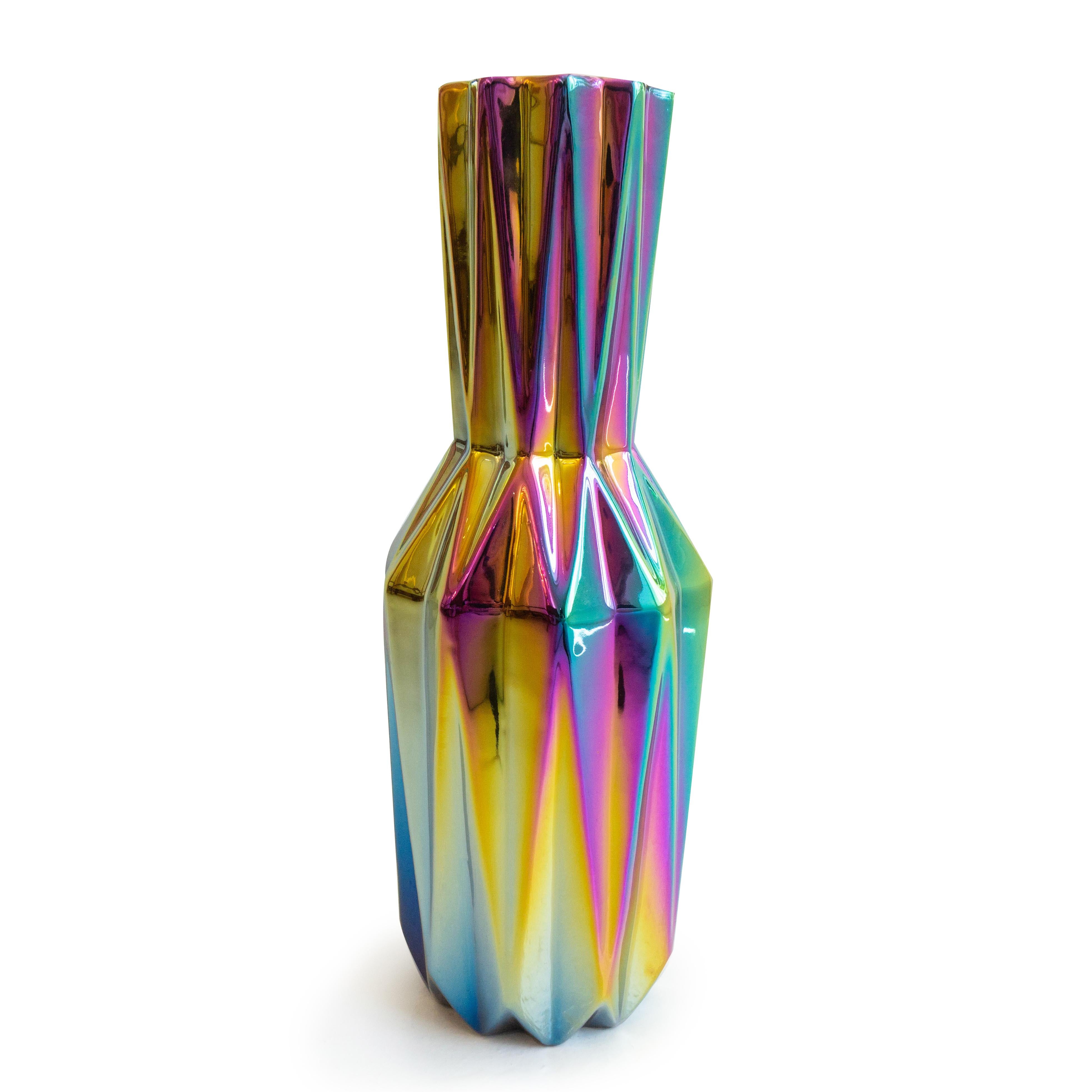 This ceramic multi-color vase features an iridescent finish that changes color accordingly with light. This vase is ideal for holding flowers or as a stand alone decorative piece. Made and designed in the Netherlands. 

Dimensions: 16” height x