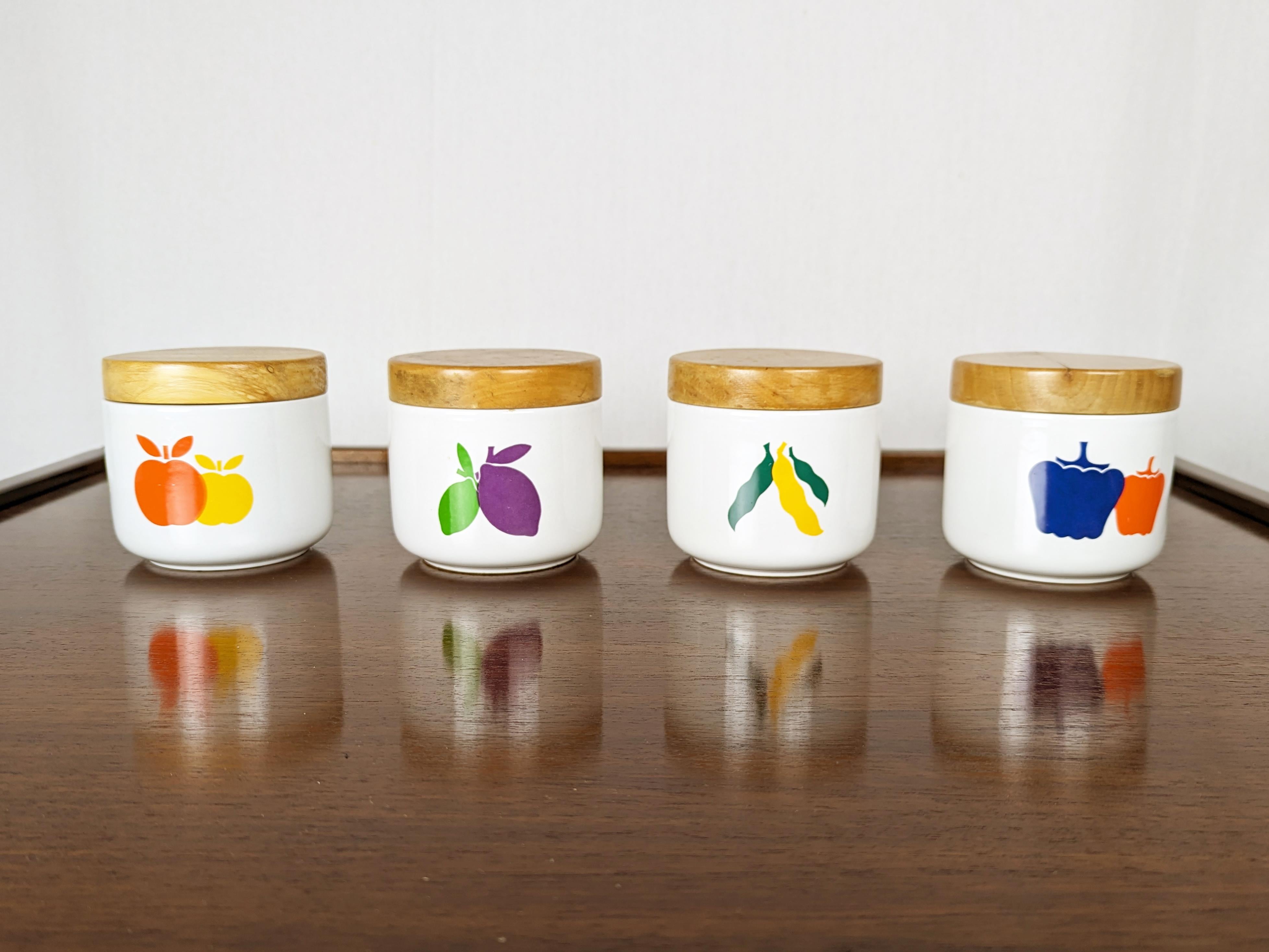 Set of 4 ceramic and wood containers with multicolred fruit decoration. Glazed ceramic and decorated with color decals fired at 820 degrees.
The wooden lids are equipped with a rubber gasket. Few ceramic defects.