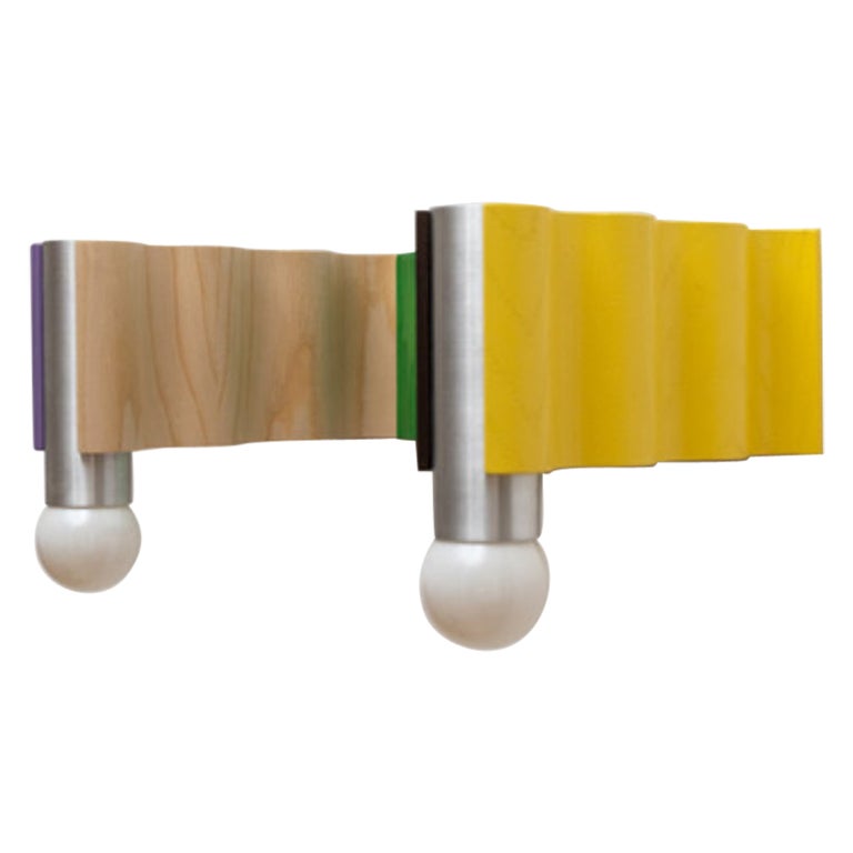Multicolored Corrugation lights double sconce by Theodora Alfredsdottir
Special Edition.
Collaboration with Tino Seubert.
Materials: Brushed aluminum tubes, ash veneered plywood.
Dimensions: D 25.5 x W 40 x H 20 cm.

Multi-colored double