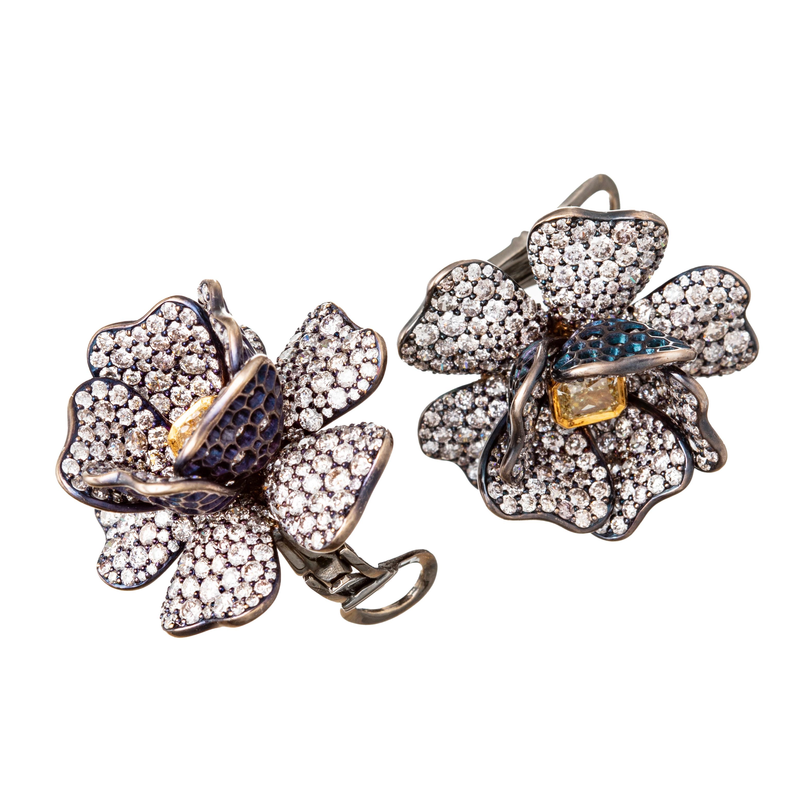 Flower earrings,  Handmade in blackened 18k gold, each centering a natural radiant-cut yellow diamond set in 18k yellow gold.   Surrounded by petals which are pavé-set throughout with white round brilliant-cut diamonds. The central fancy yellow