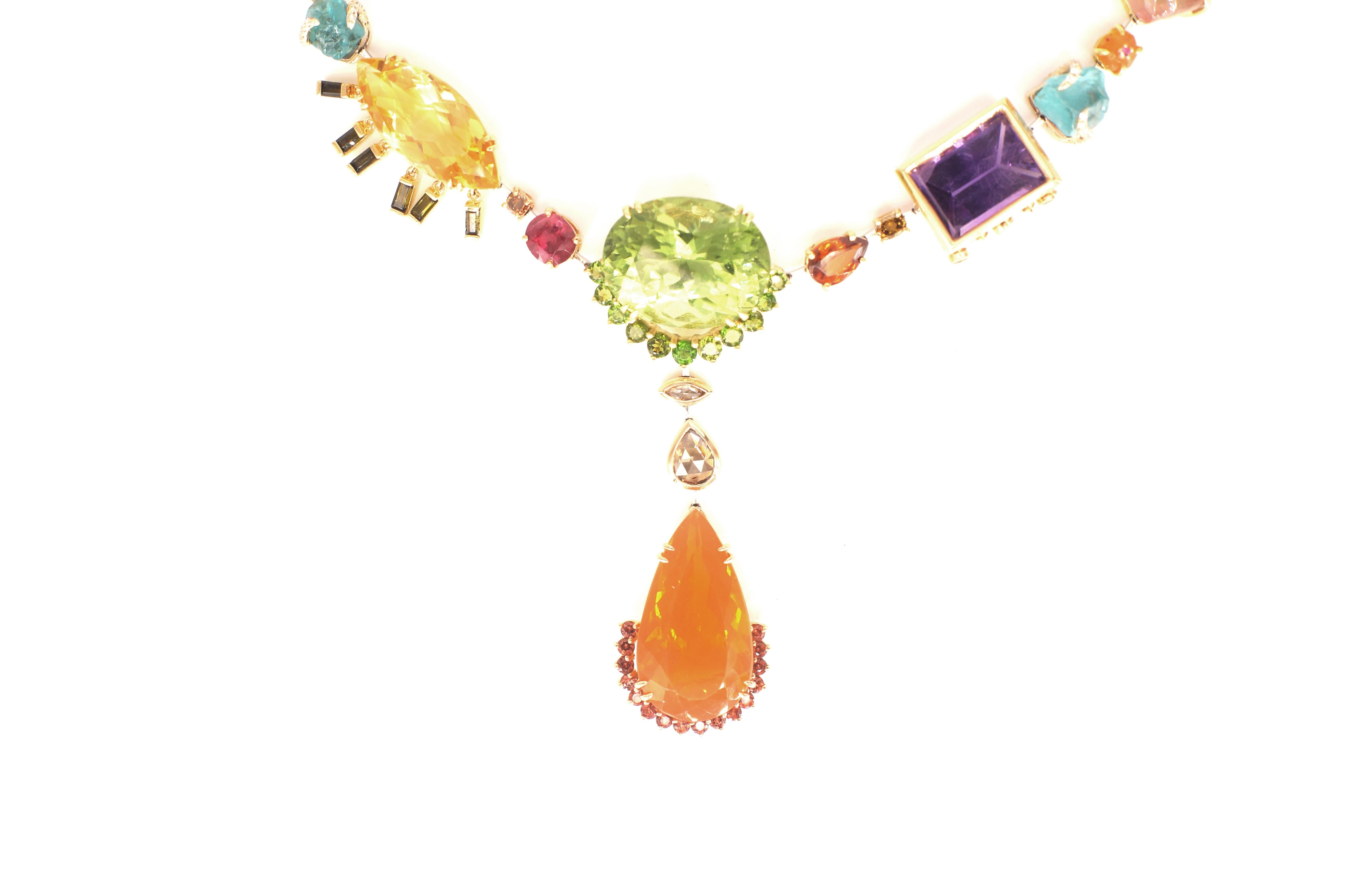 Tori Necklace
An entirely handmade necklace created in eighteen-karat gold and platinum, set with different colours and shades of natural gemstones and diamonds.  This piece begins with a central motif consisting of a 24.45 carat peridot, suspending