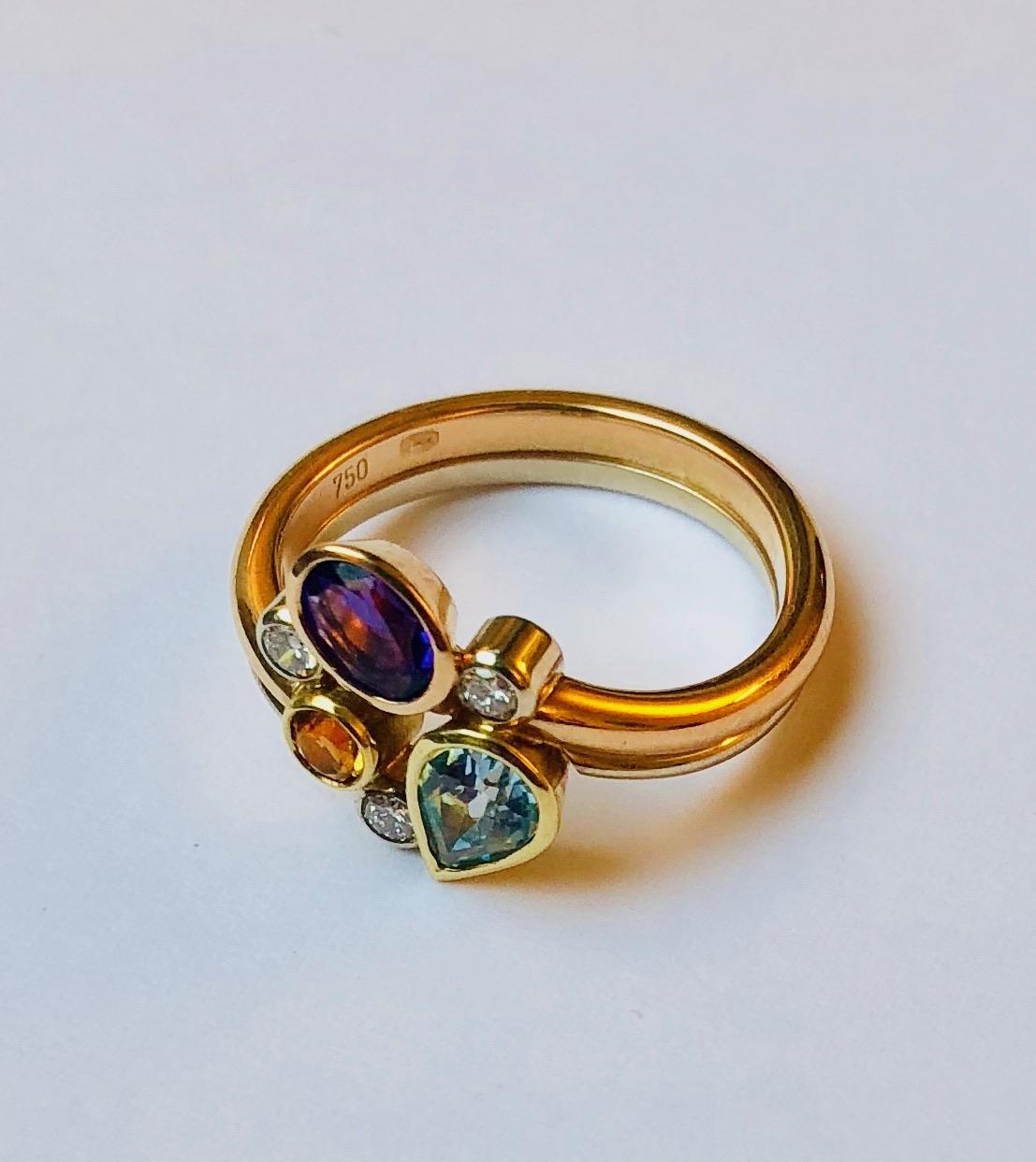This stunning ring features several gemstones, such as topaz, emerald, diamond and amethyst. Each stone is set in white, yellow or rose 18kt gold, depending on the color as to best accentuate it.

This pendant was designed and made by Van der Veken,