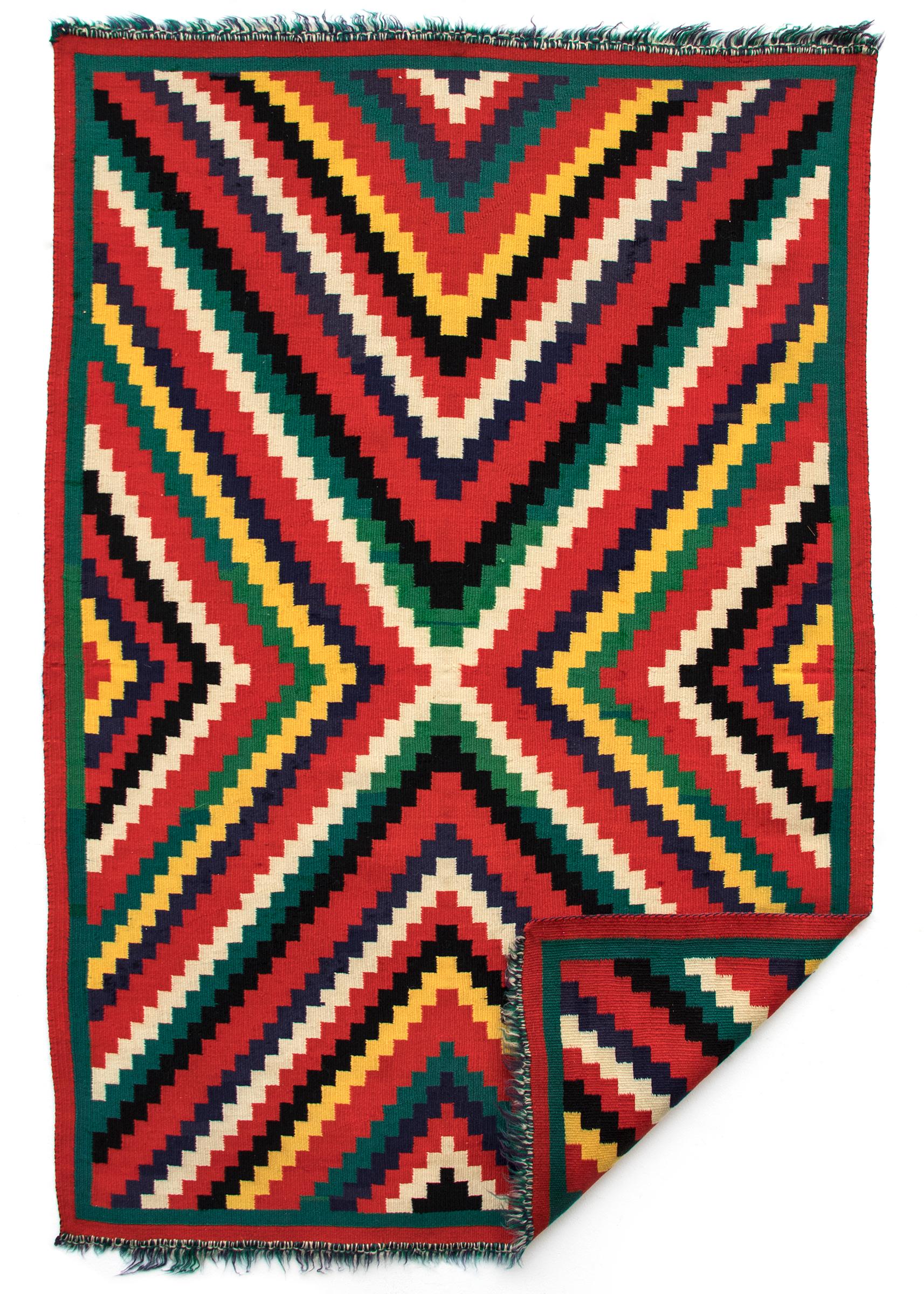 19th century circa 1890 Navajo blanket textile woven of Germantown Yarns in an Eyedazzler pattern of vibrant colors including red, green, yellow, black and white. Germantown textiles like this were woven by Native American Navajo weavers in the late