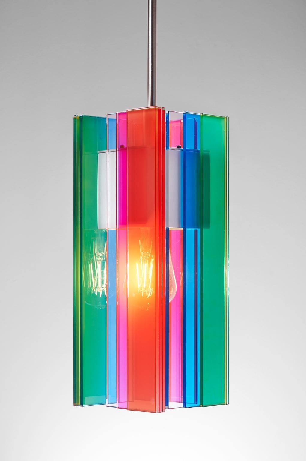 Designed and created by Sidney Hutter glass and light, this pendant has an ultra-contemporary style that looks good in any environment. The pendant is created by laminating clear glass pieces using UV adhesive to the nickel plated aluminum housing.