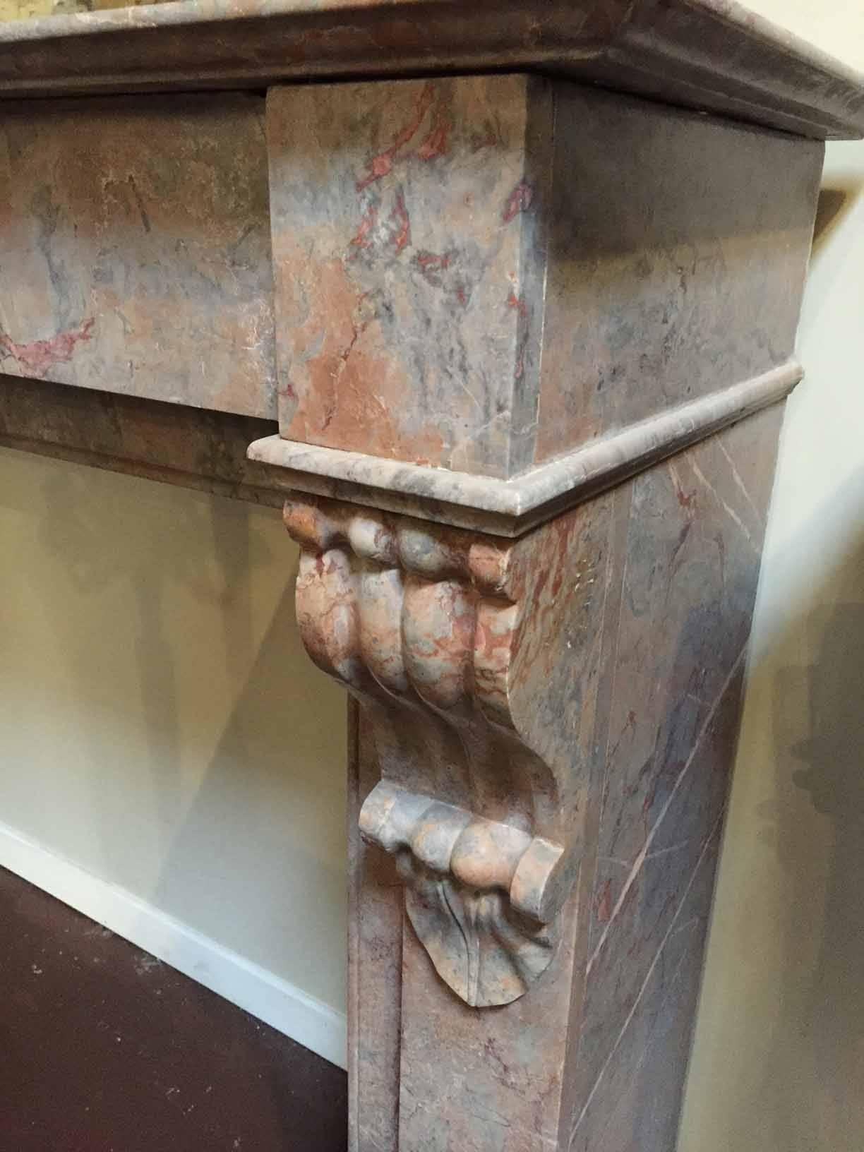 In rose Enjugerais marble, this antique mantel features a simple lintel and a scroll-like design on top of each leg.

Origin: France,

circa 1880. 

Measurements: 53 3/4