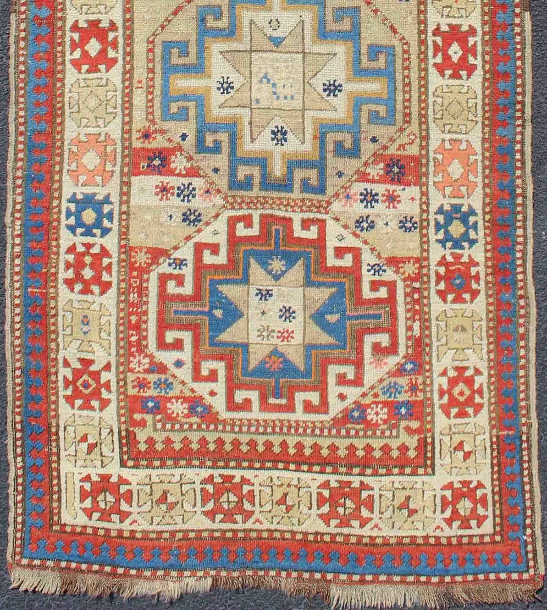 Geometric Medallion antique Caucasian Kazak rug in lighter tones. rug 19-0811, country of origin / type: Iran / Caucasian Kazak, circa 1880.
Kazak rugs are among the most desirable Caucasian rugs. The vibrant reds, blues, and ivories that decorate