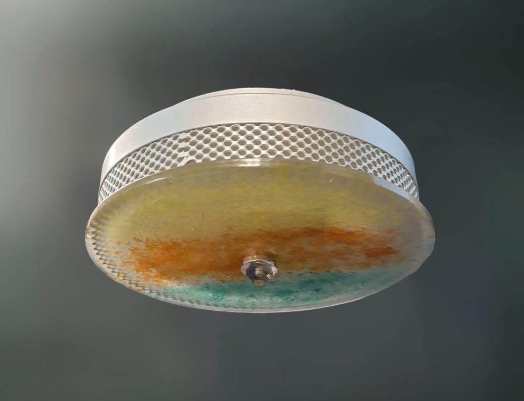 Vintage mid-century Italian flush mount with a round Murano glass diffuser in yellow red and green color, mounted on perforated white metal frame and secured with a clear glass finial / Made in Italy in the style of Venini, circa 1960s
Measures: