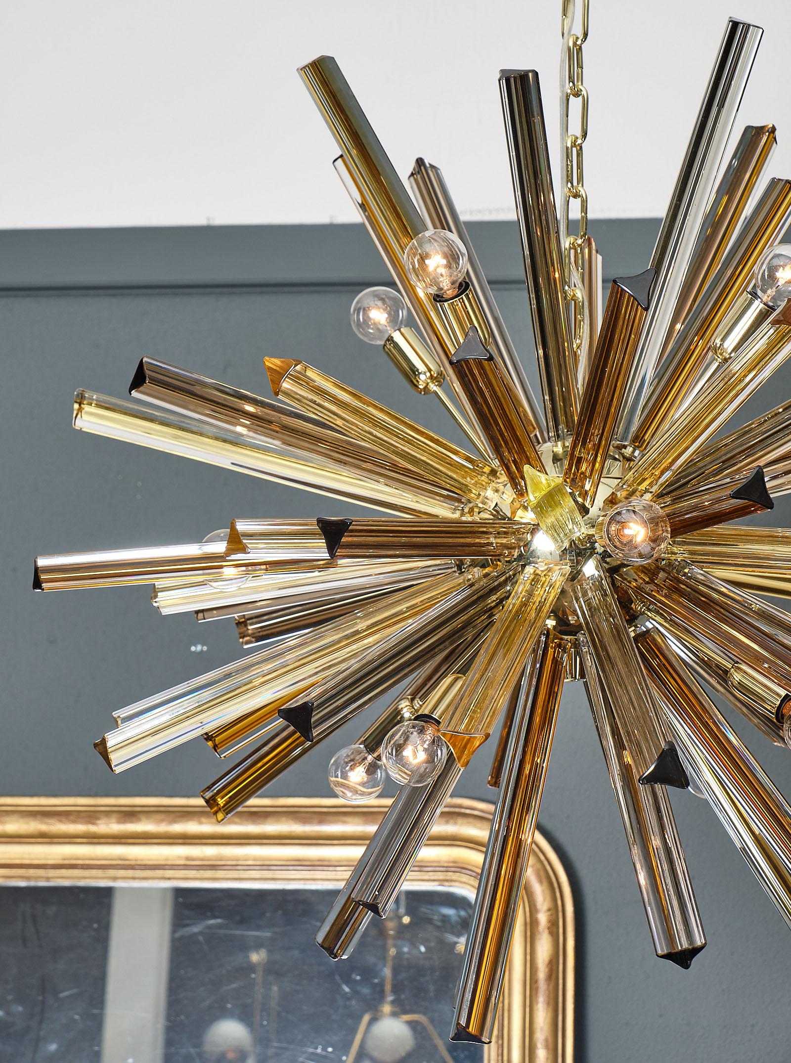 Murano glass multicolored Sputnik featuring glass pieces in amber; tea; gray; and citrine colors. The structure is brass. This piece has been newly wired to fit US standards.
 
This fixture is currently located at our dealer's warehouse in Italy.
