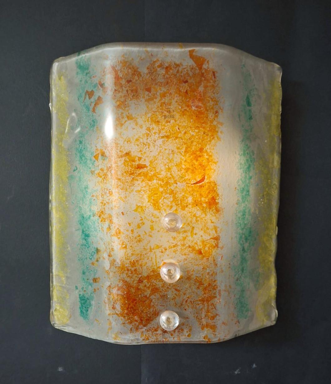 Vintage mid-century Italian wall light with a Murano glass shade in yellow red and green colors, mounted on white metal frame and secured with clear glass screws / Made in Italy in the style of Venini, circa 1960s
Measures: height 12 inches, width