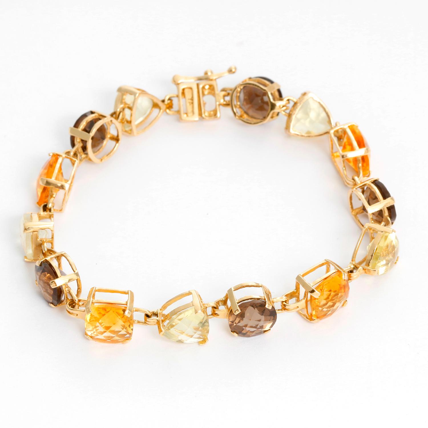 Multicolored Quartz and Citrine Set  - This bracelet and drop earrings with round- faceted smoky quartz, cushion -faceted Citrines and trianagle -faceted green quartz. Set in 14K Yellow gold. Will fit a 7 inch wrist. The earrings are 2 inches long.