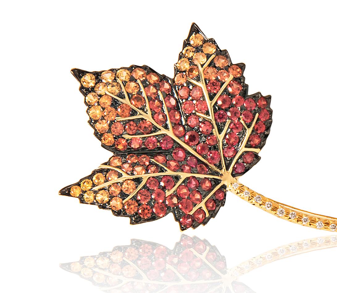 Multicolored sapphires in autumn shades of yellow, orange and red highlight this naturalistic leaf form brooch. Vibrant round brilliant diamonds trace the elegant line of the stem.

2” long by 1” wide
Approximately 1.50 carats of round brilliant
