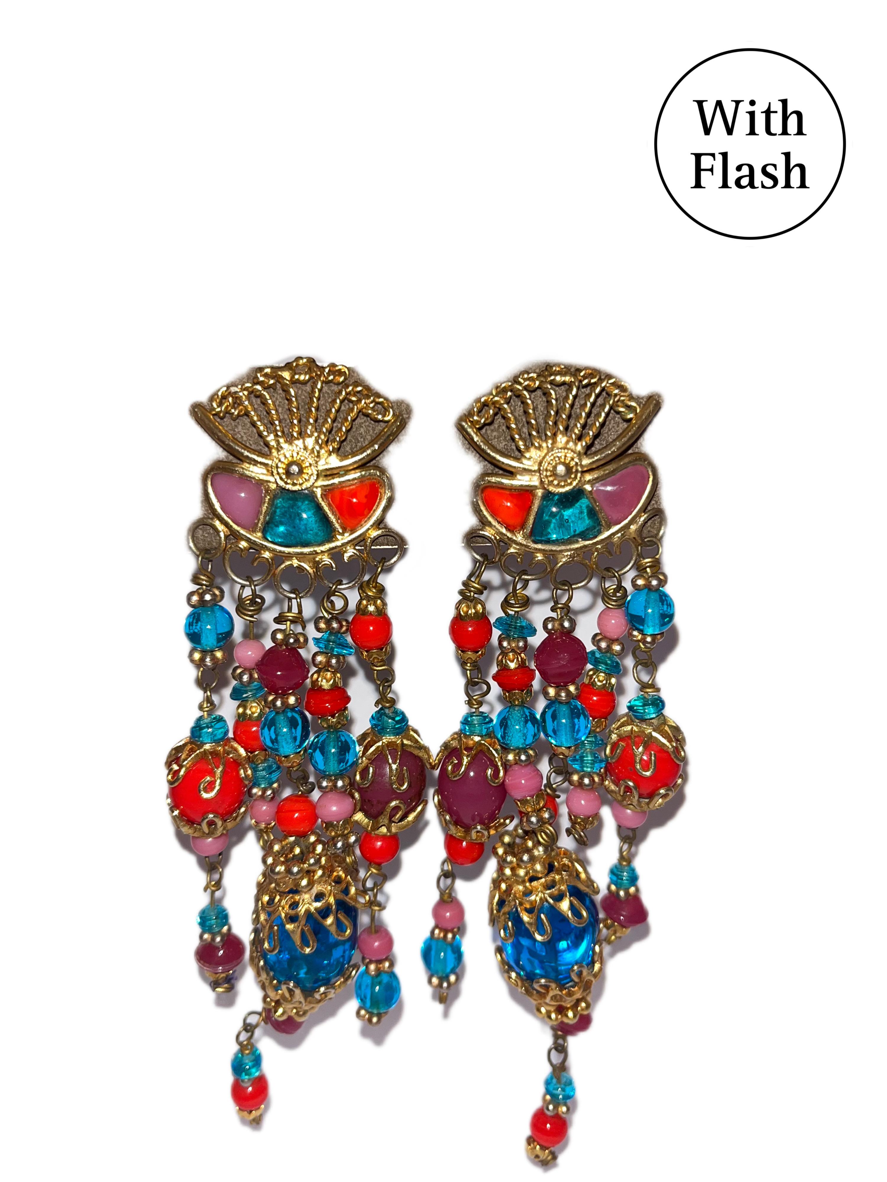 This colourful pair of clip-on earrings is from Yves Saint Laurent. The jewellery is not signed, as is usually done in the Haute Couture house. The earrings are gold-toned, and made of metal. The beads are made of glass. The colours of the beads are