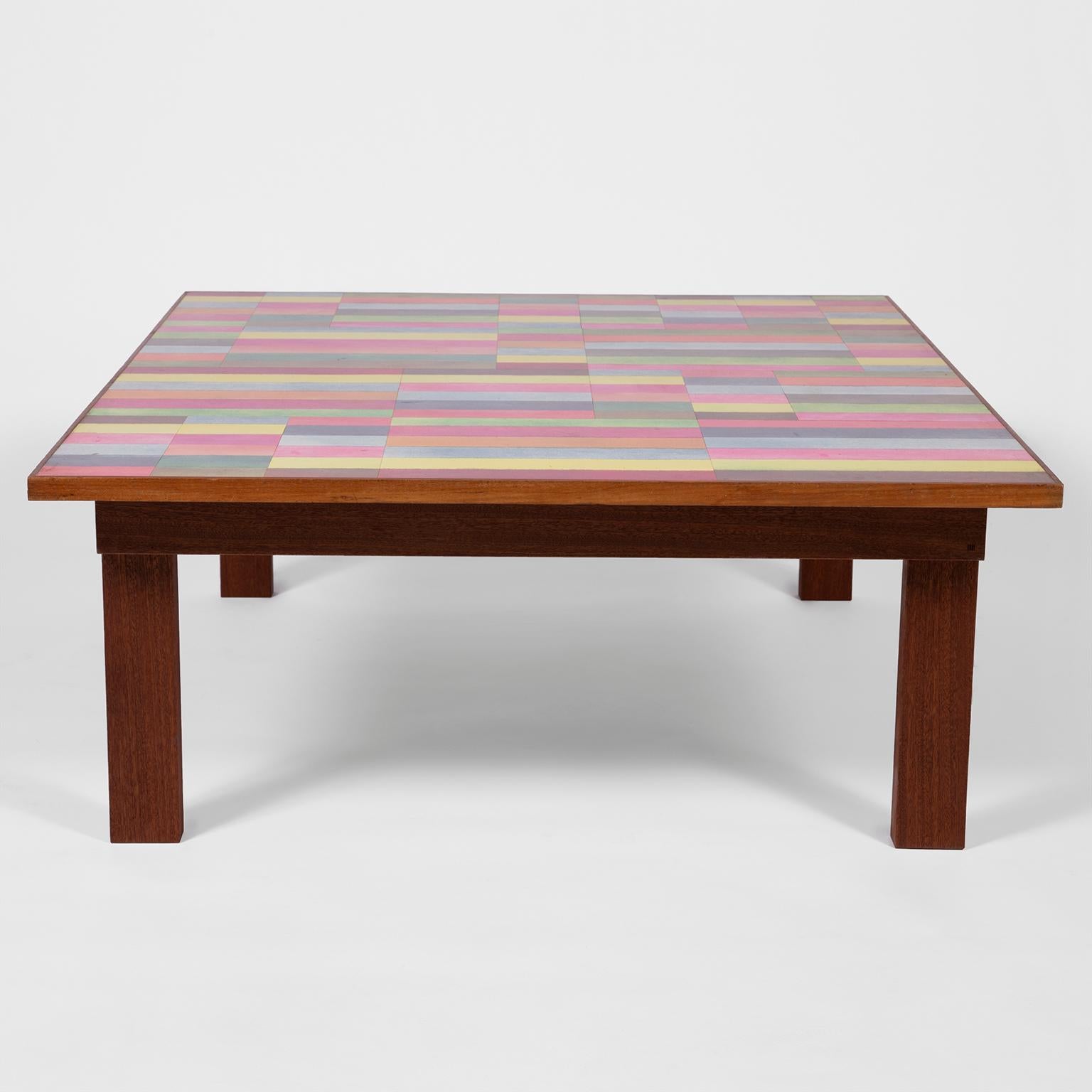 Low rectangular table featuring the original 1960s laminated mix media surface art by Barry Daniels as part of the DANAD Design collective (1958-1962).
The original laminated surface art is set in a Sapele Mahogany, handcrafted in the UK, based on