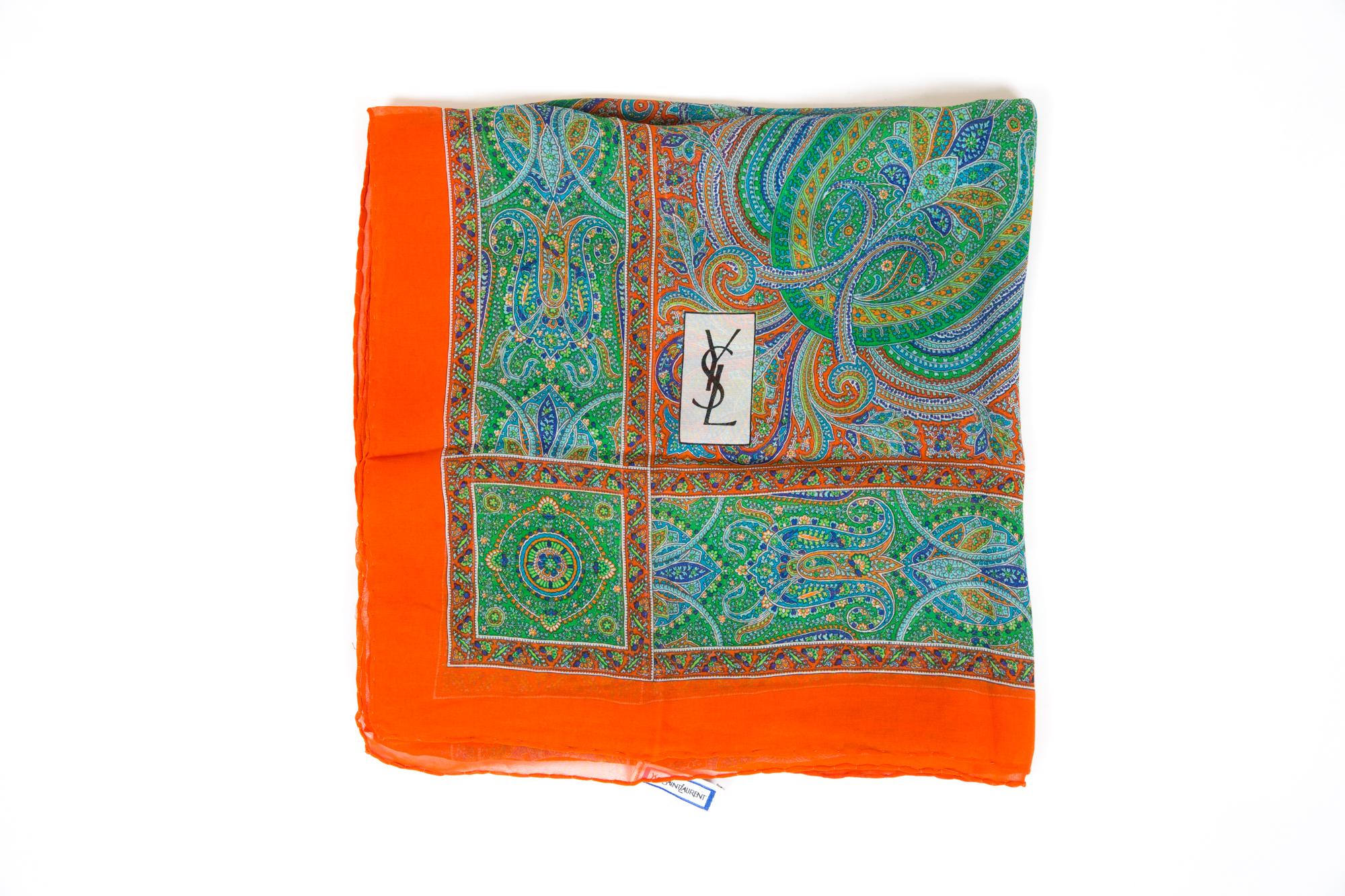 Gorgeous Saint Laurent YSL multicolour silk georgette scarf featuring  a paisley motive, an orange outline, and a top logo signature.
Marked YSL
55.1 in. (140 cm) X 51.3in. (130cm)  In good vintage condition.  
Made in France.  
We guarantee you