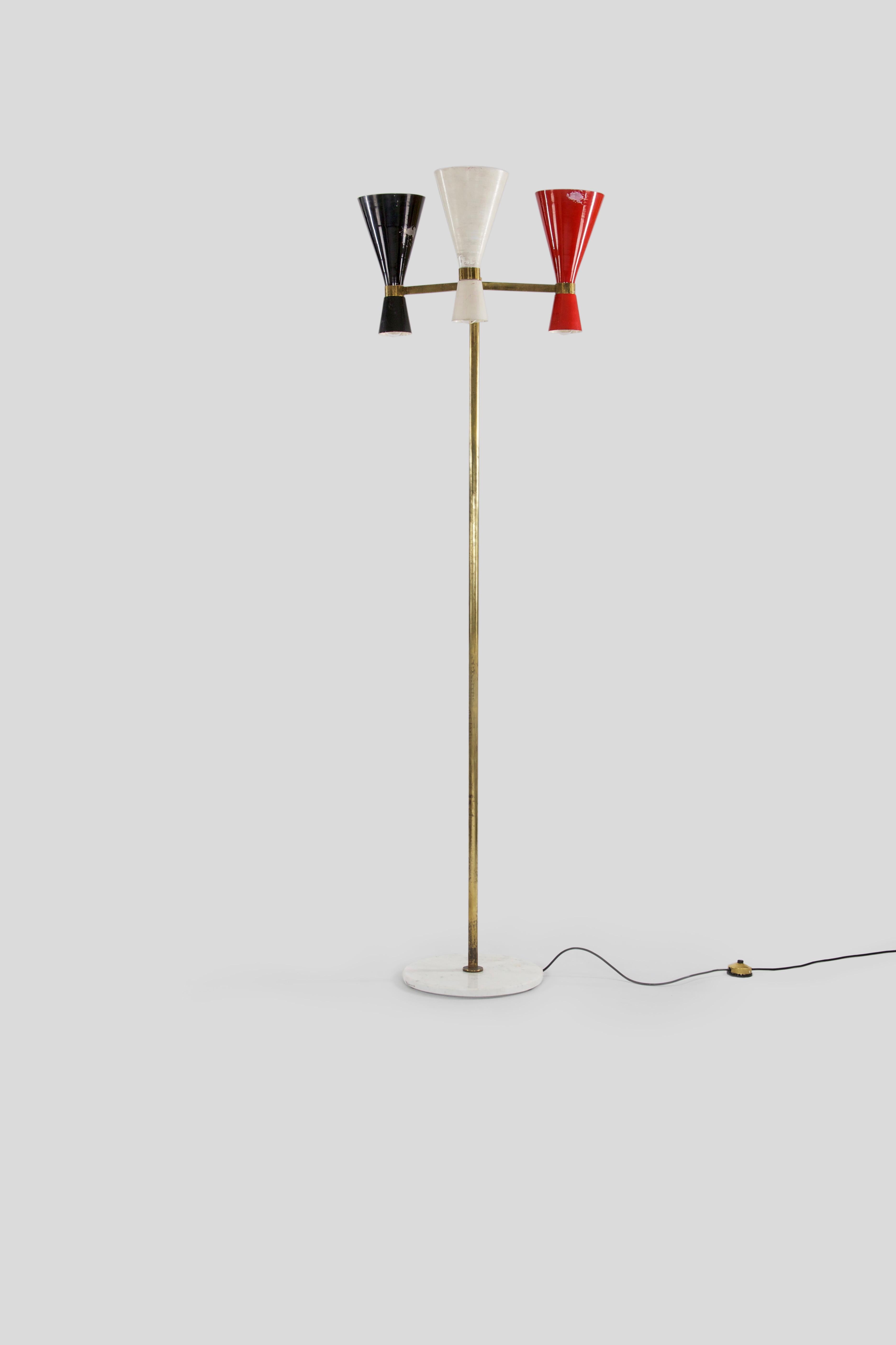 This brass floor lamp was manufactured in Italy, 1950s. It has three multicoloured - red, white and black - lacquered metal shades and a marble base. 

Feel free to contact us for more detailed pictures.