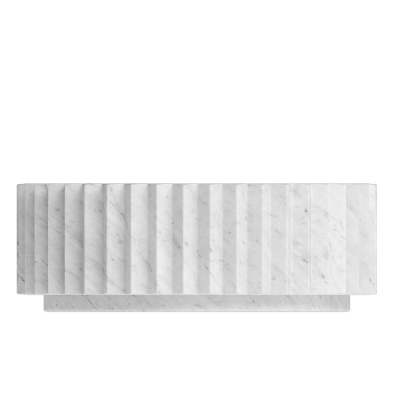 Inspired by Doric columns in archaic architecture, this extruded multi-point star coffee table is carved in white Carrara marble. Similar to gears, two or more of these tables, possibly of different sizes and heights or even materials, can be meshed