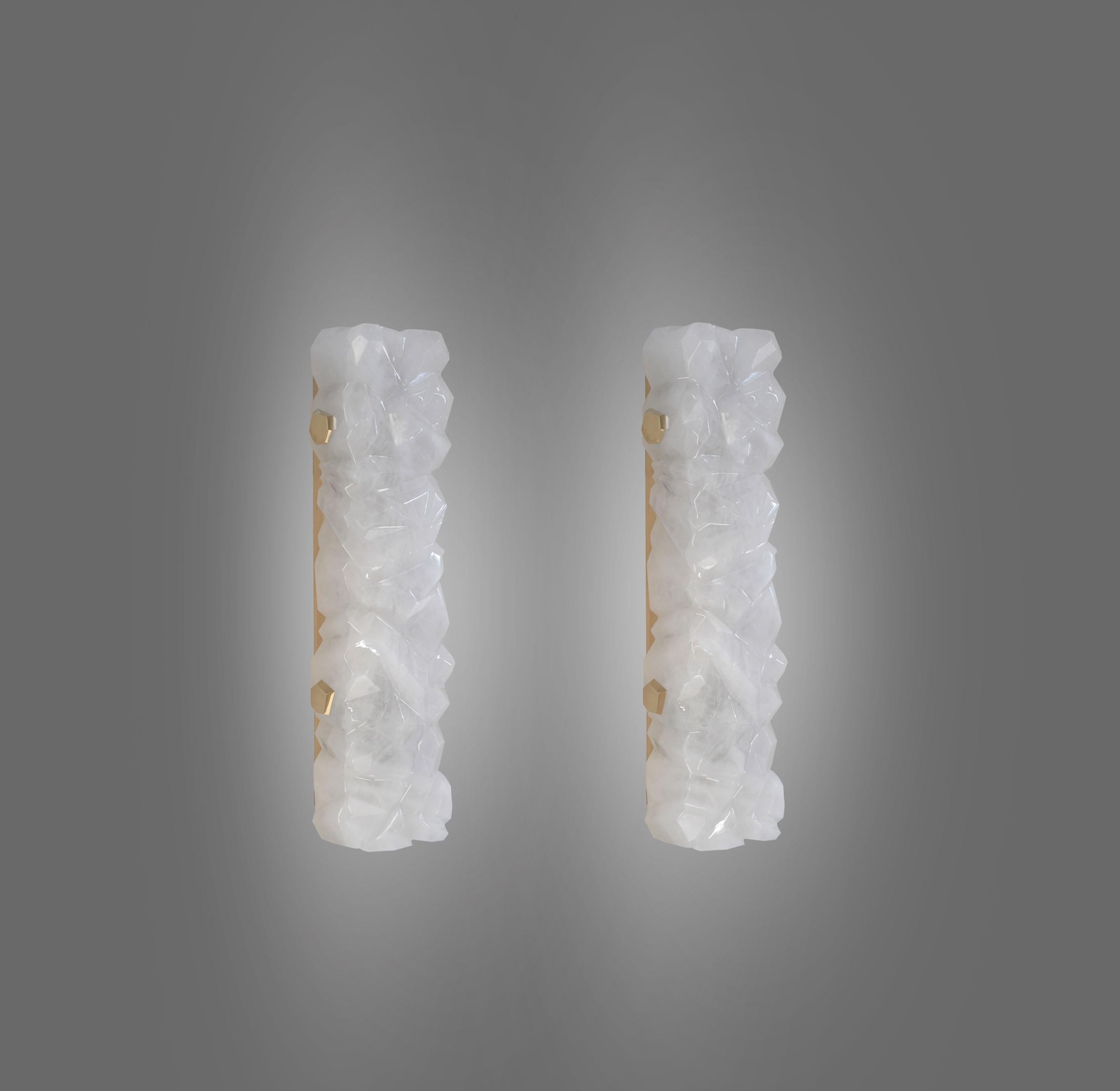 Tall pair of fine carved multifaceted abstract form rock crystal sconces with polish brass decoration. Created by Phoenix Gallery, NYC.
Metal finish, size, and quantity upon request.