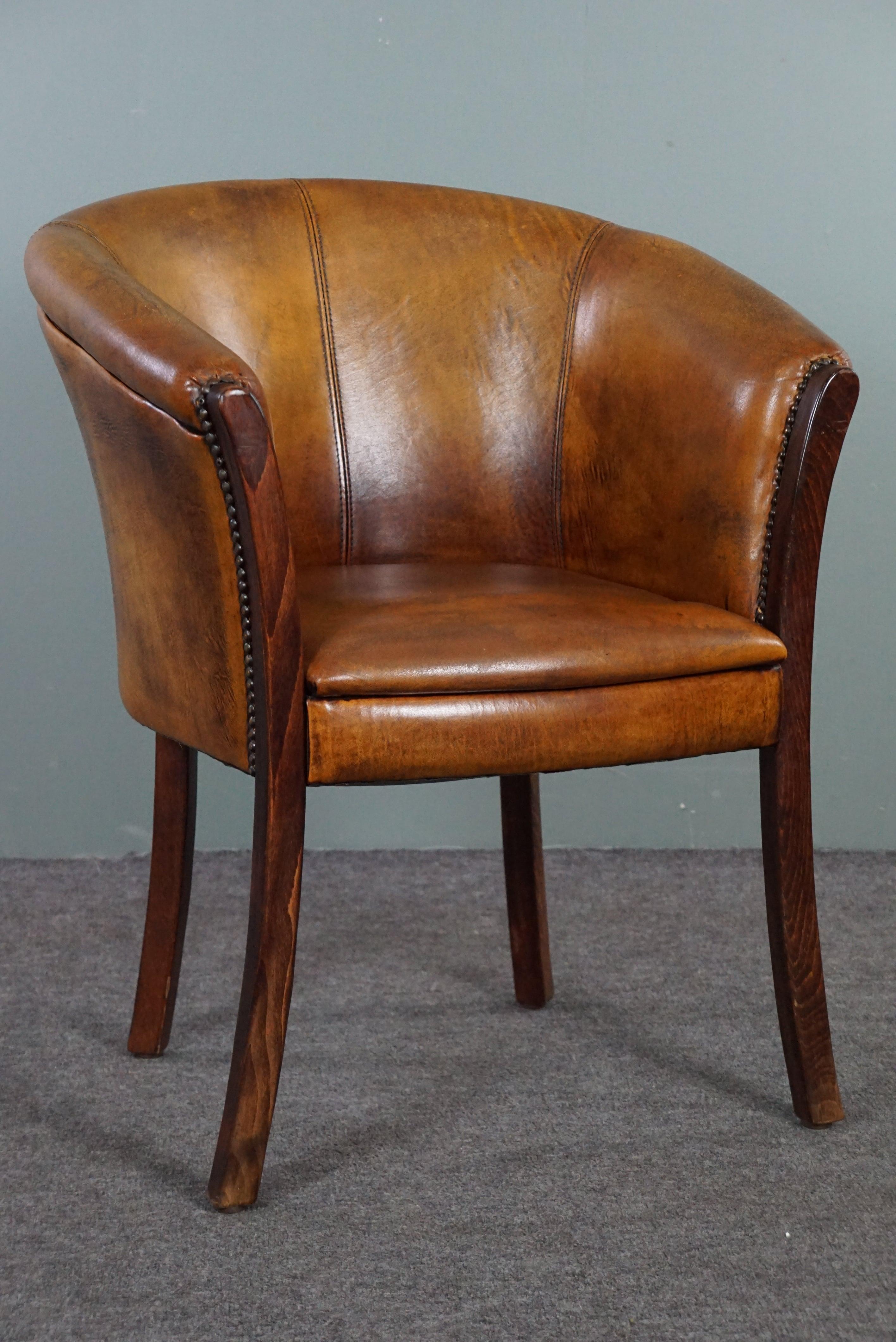 Offered is this beautiful sheep leather chair finished with decorative nails.

This sheep leather side chair/armchair is multifunctional due to its modest size and higher seat height. This makes this sheepskin tubchair suitable for use as a side