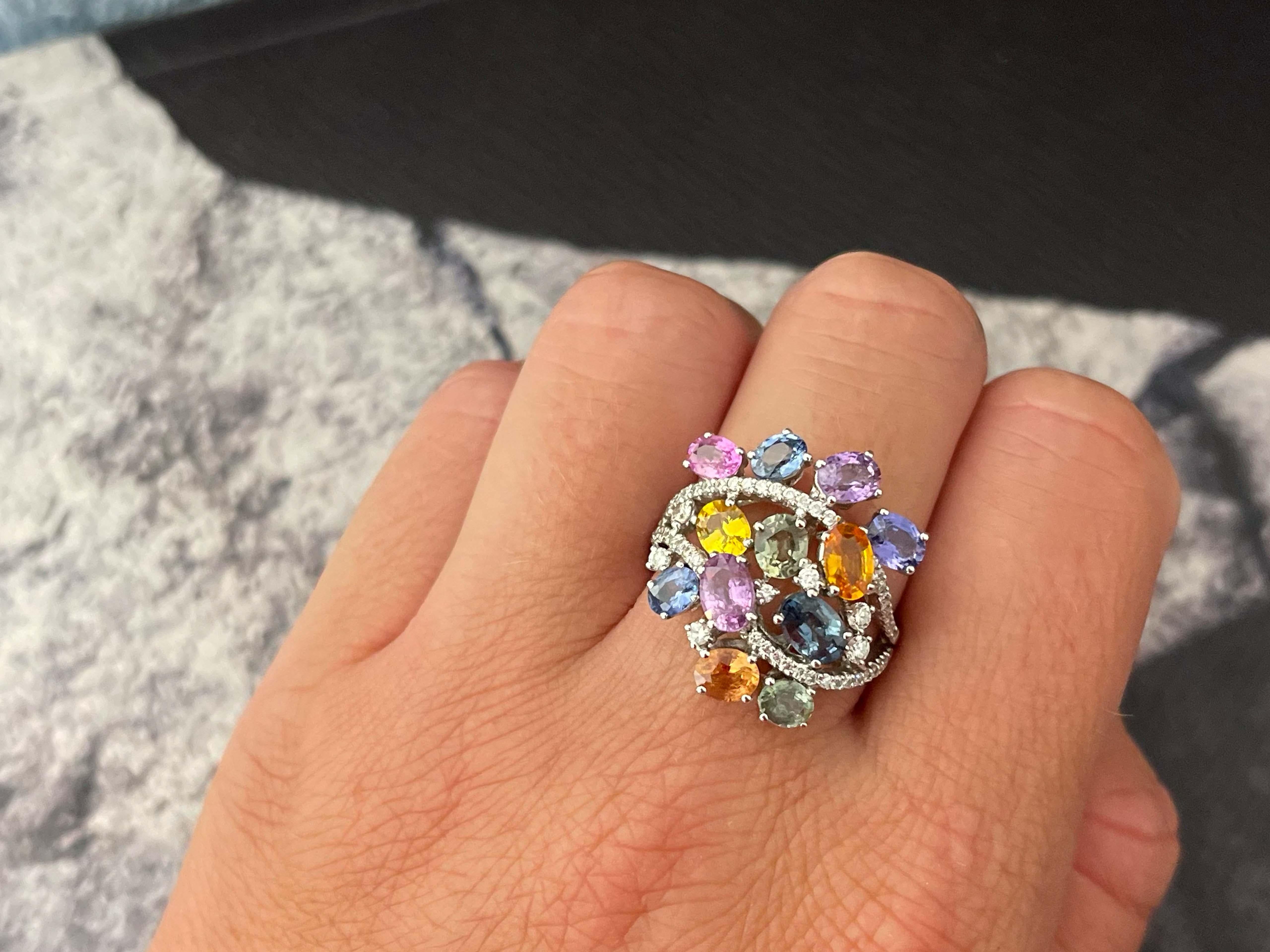 Item Specifications:

Metal: 18k White Gold

Style: Statement Ring

Ring Size: 8.25 (resizing available for a fee)

Total Weight: 8.4 Grams
​
​Gemstones: pink, yellow, blue topaz, purple and green amethyst, purplish blue tanzanite
Diamond Count: