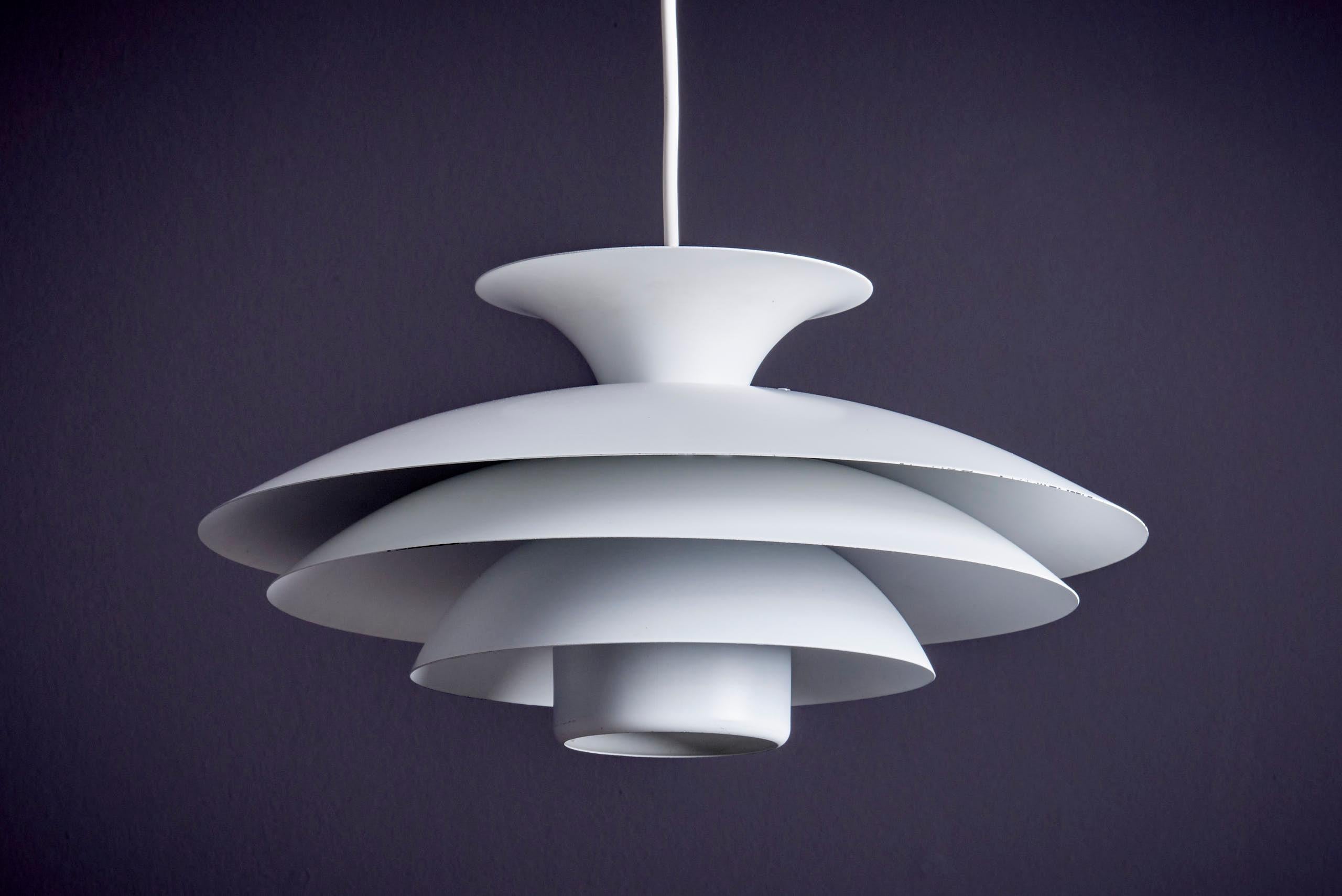 Featuring layered discs and a soft, diffused glow, this pendant captures the essence of mid-century Scandinavian design. Likely produced by Form-Light, it combines glare-free illumination with sculptural elegance. A timeless piece, ready to hang and