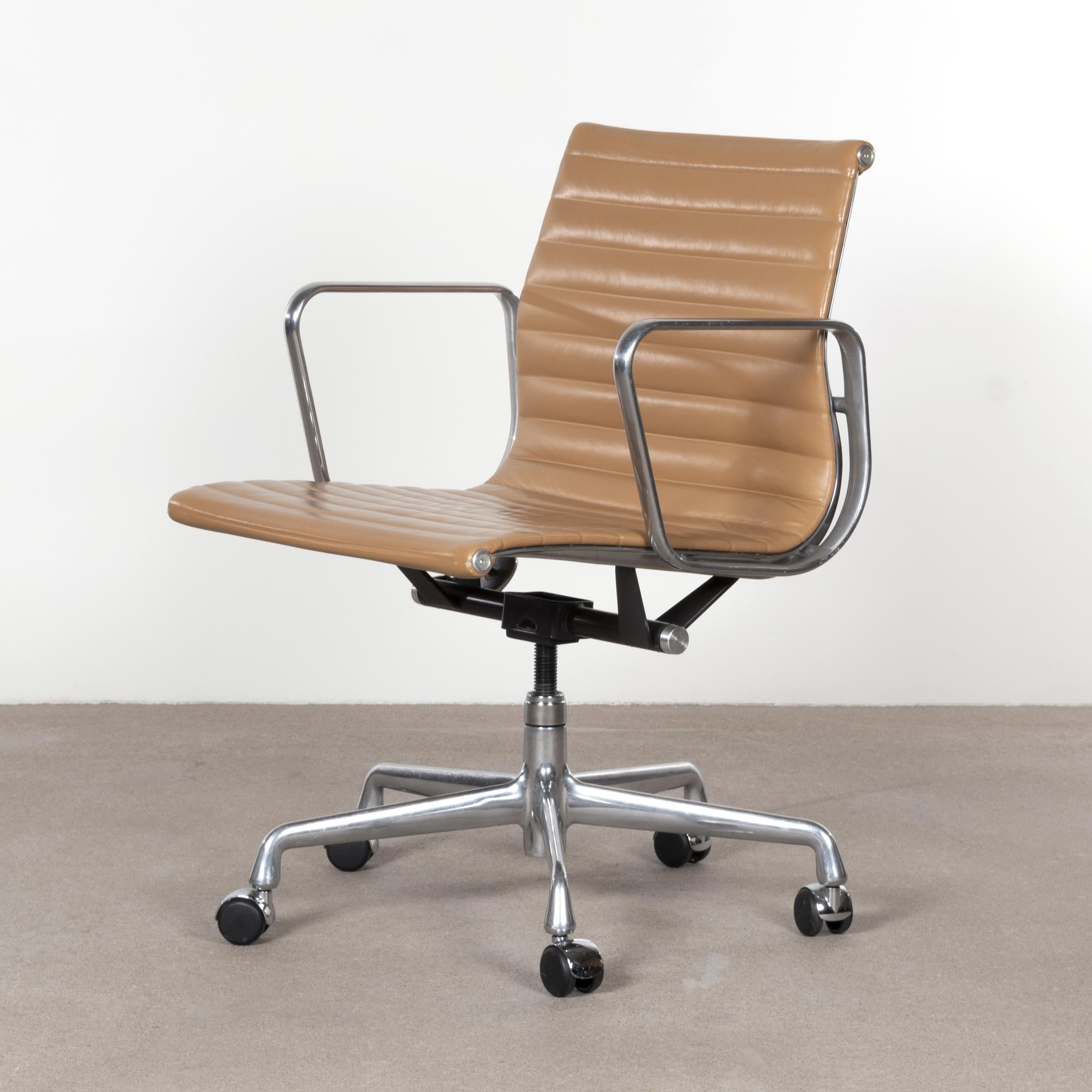 Eames EA335 management office chair in cognac leather with five-star base, spindle and tilt-swivel mechanism. Good original condition signed with manufacturer's label. Multiple chairs available.