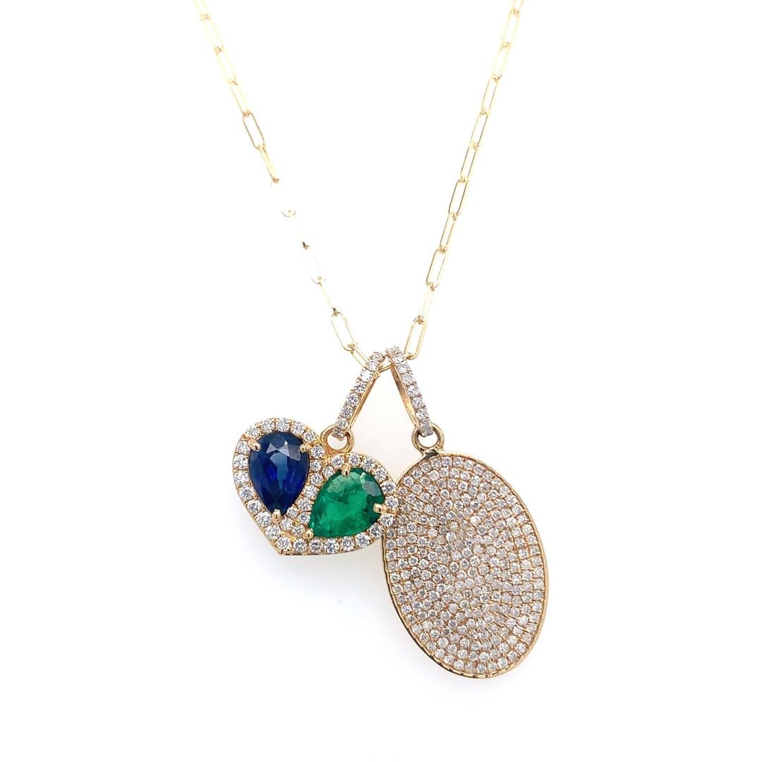 This is a multi-pendant  necklace. Two of the pendants are on an adjustable chain; one of the pendant is formed entirely of diamonds, while the other is a heart-shaped pendant with diamonds, emerald, and sapphire.  Real emerald, sapphire, and